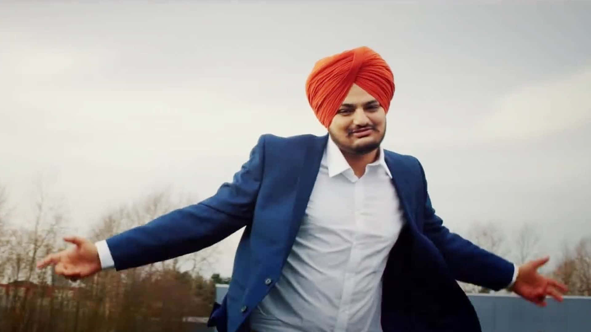 A Man In A Turban Is Dancing In The Air