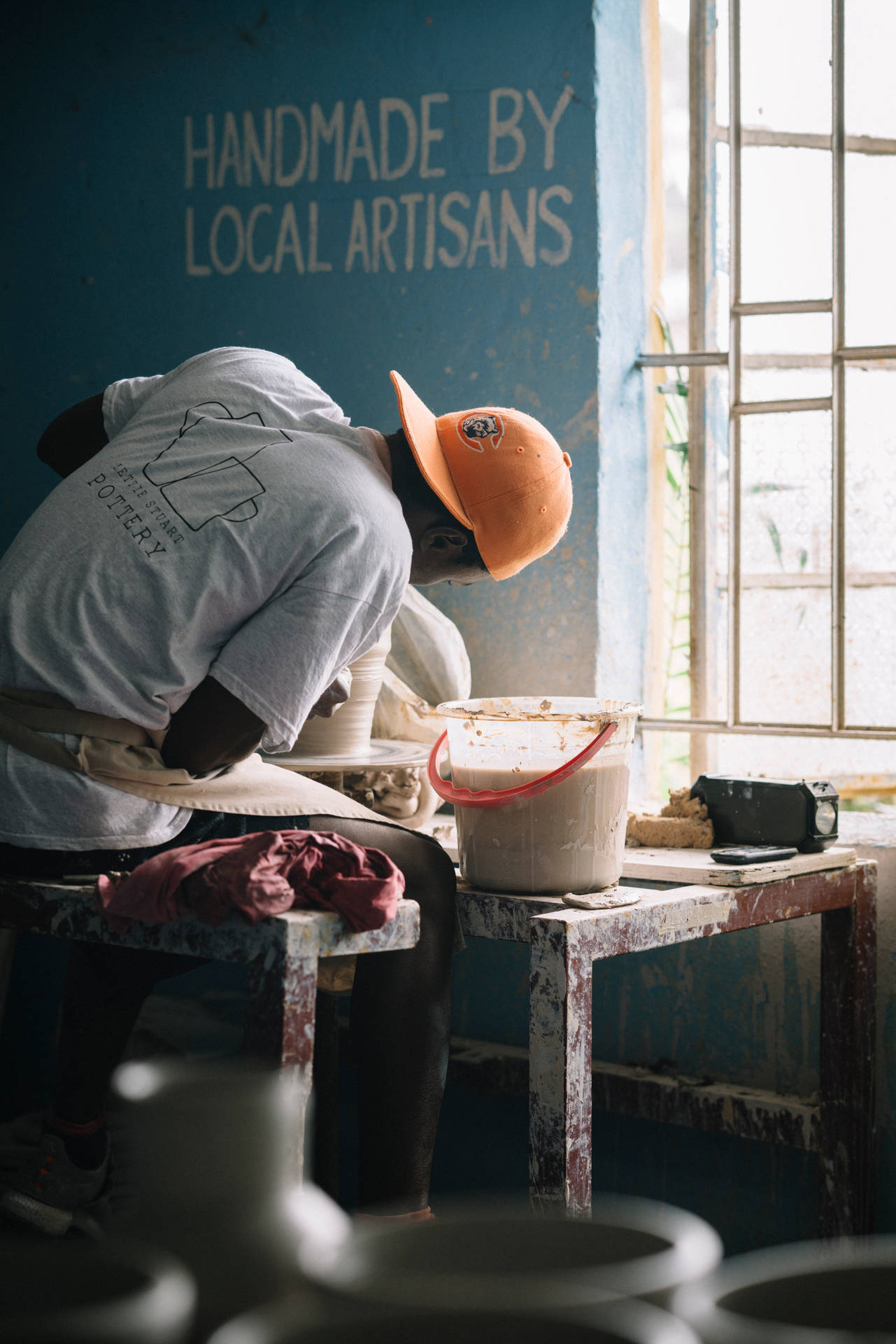 Sierra Leone Man With Back Turned Making Pottery Wallpaper
