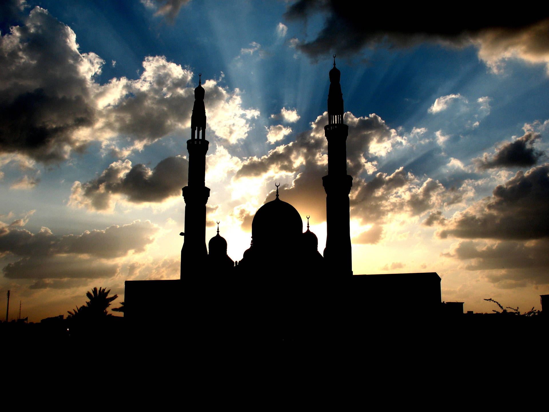 A beautiful nighttime silhouette of an Islamic mosque. Wallpaper
