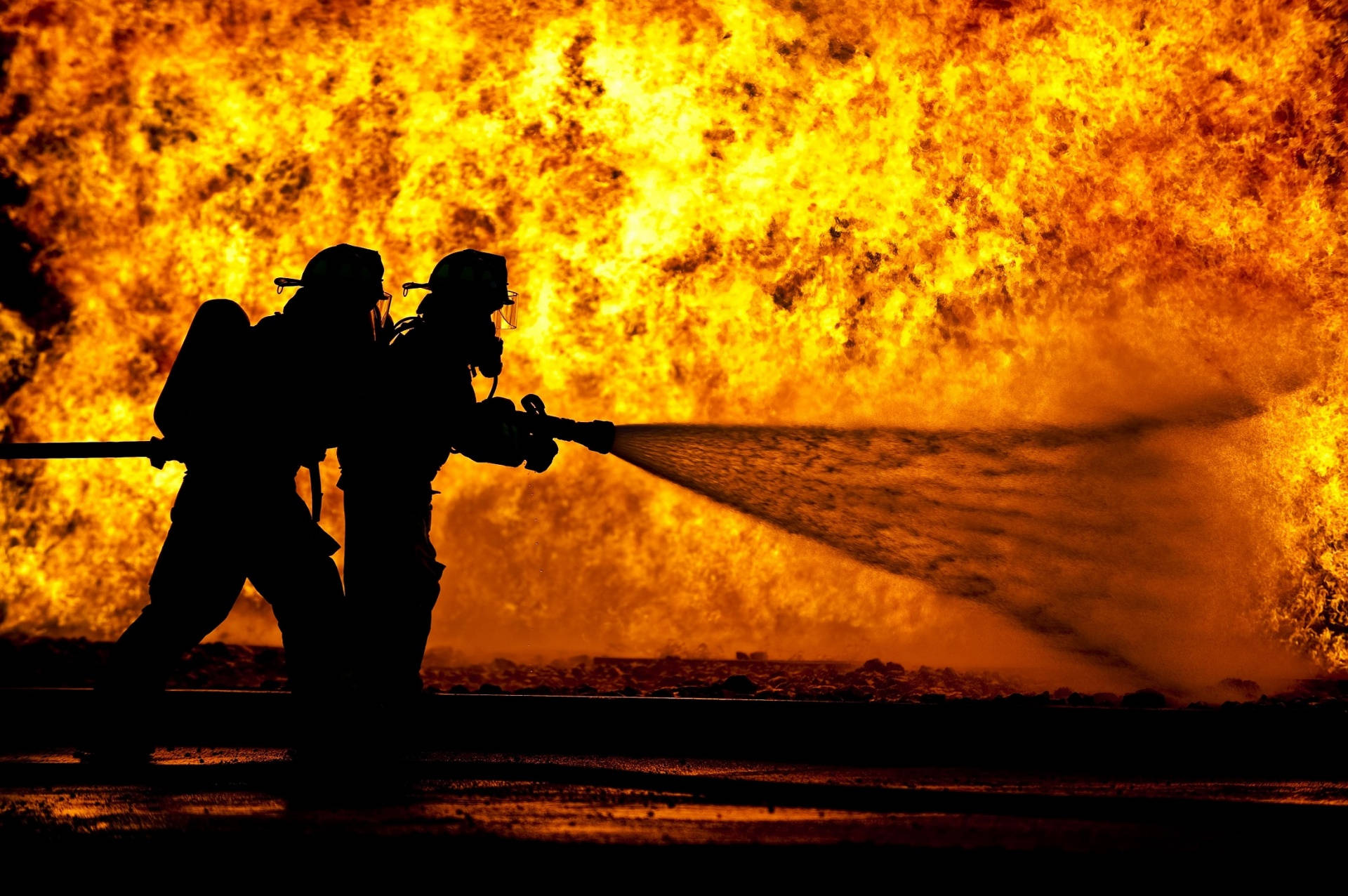 Silhouette Of A Fireman Against A Monstrous Fire Wallpaper
