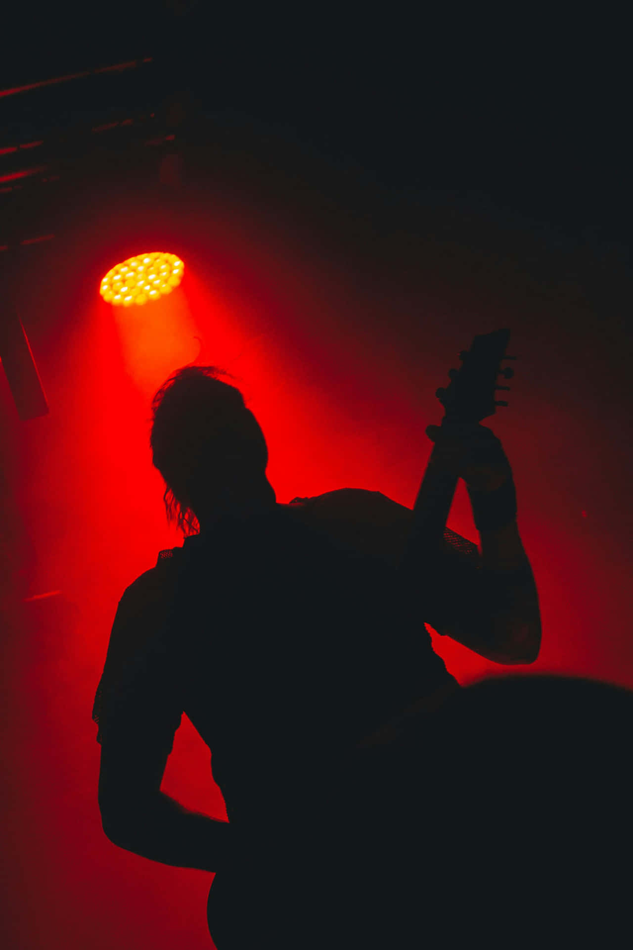 Silhouette_of_ Guitarist_ Under_ Red_ Spotlight Wallpaper