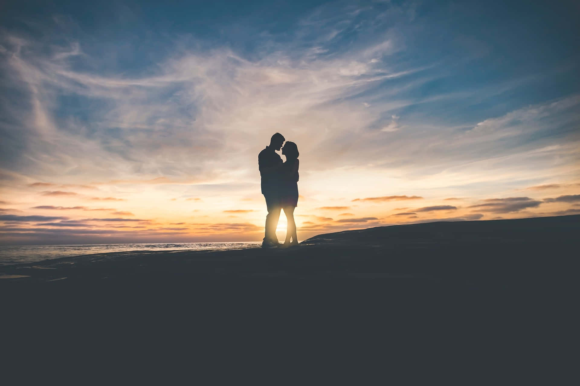 Silhouette Shot Of A Tangible Couple Under The Gorgeous Sky Wallpaper