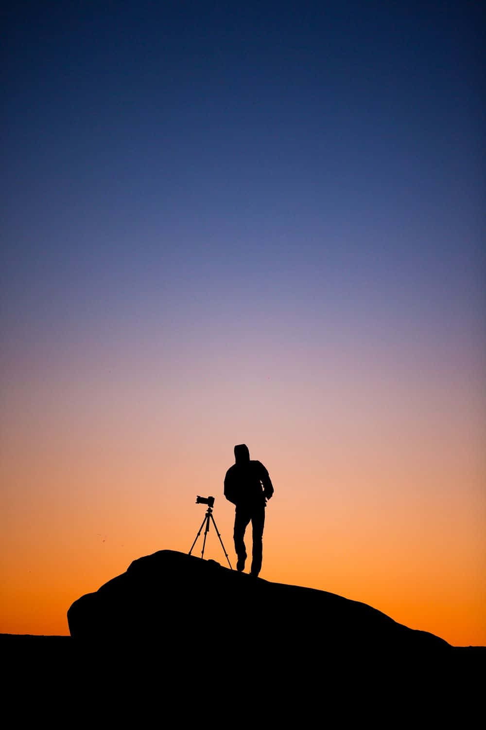 Silhouetted Cameramanat Sunset Wallpaper