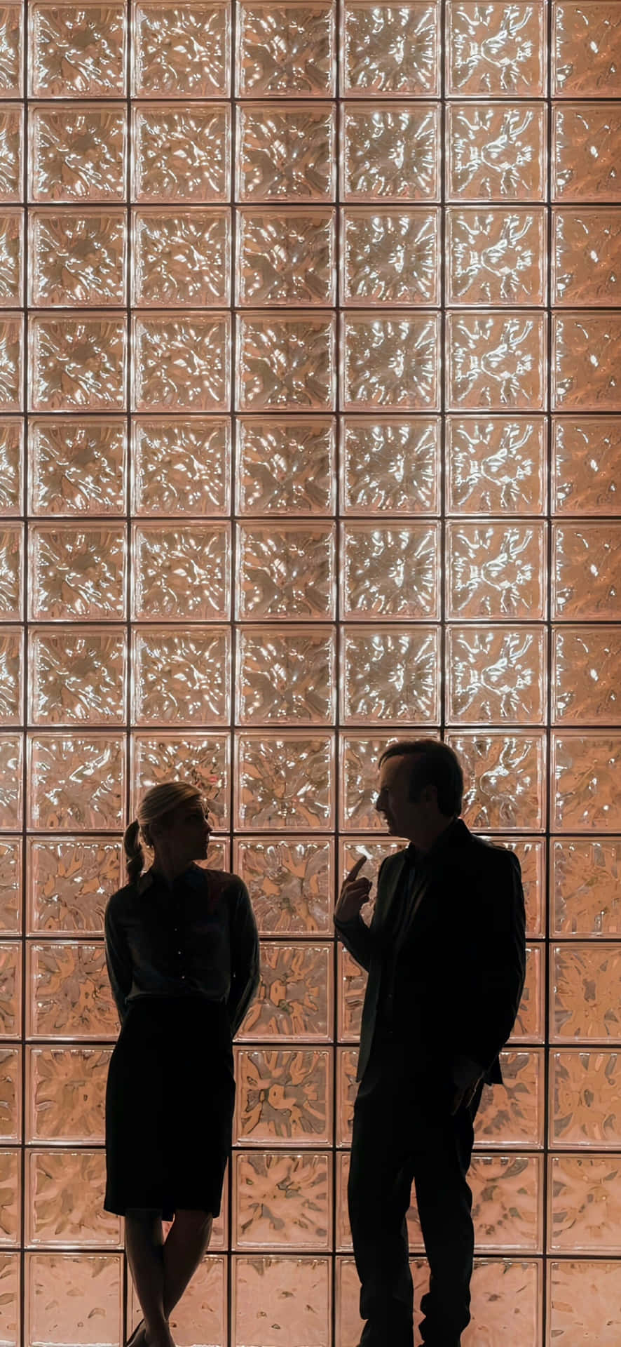 Silhouetted Conversation Against Decorative Wall Wallpaper