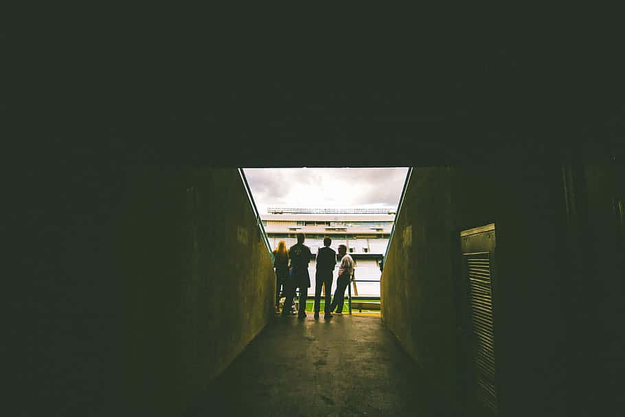 Silhouetted People Exiting Tunnel Wallpaper