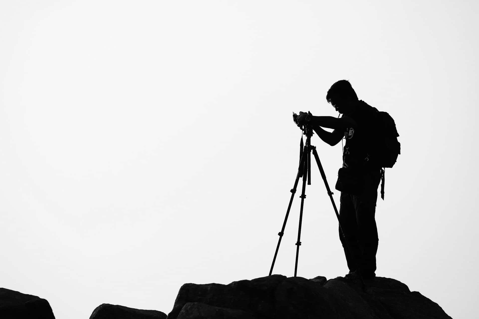 Silhouetted Photographeron Rocky Outcrop Wallpaper