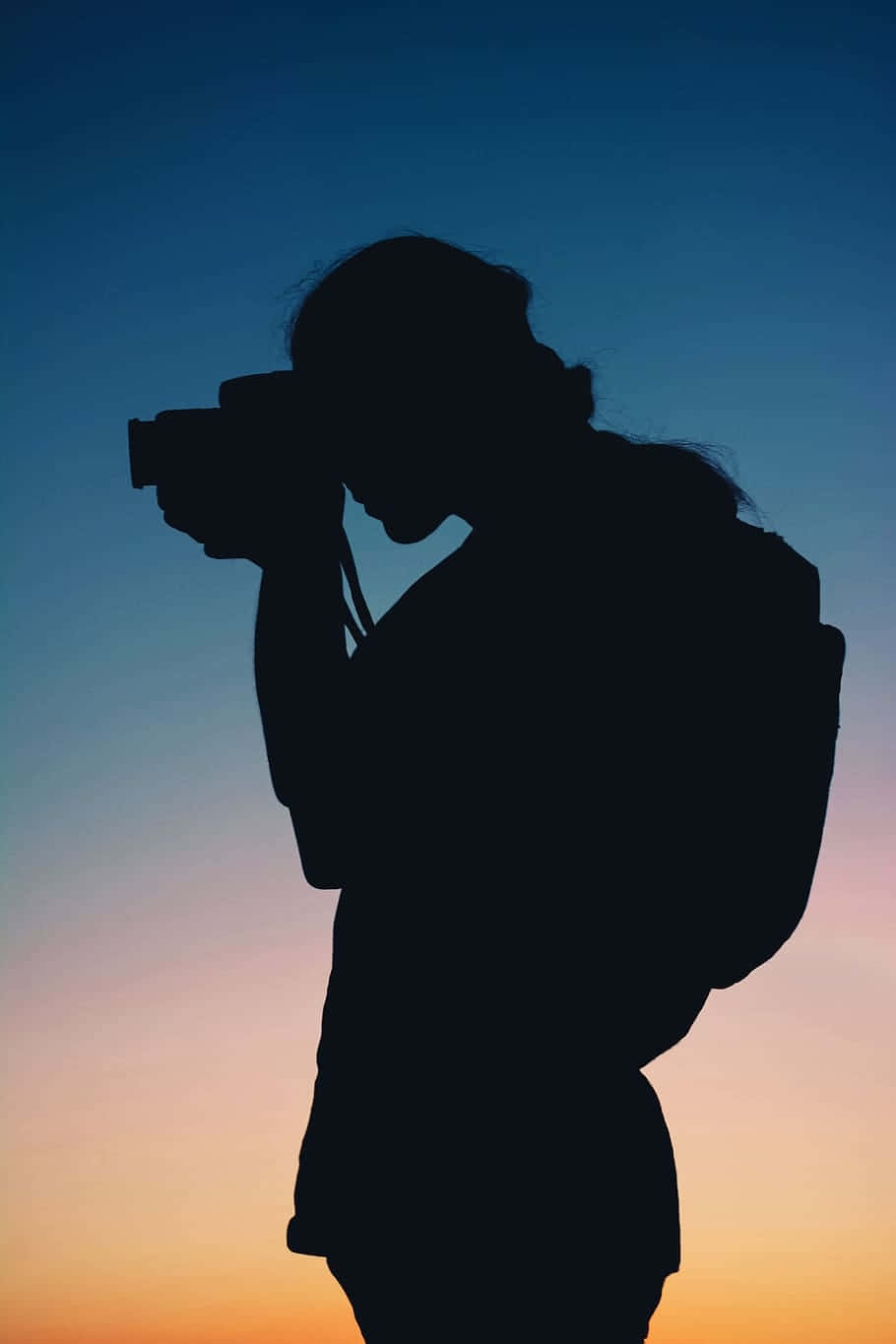 Silhouetteof Photographerat Sunset Wallpaper