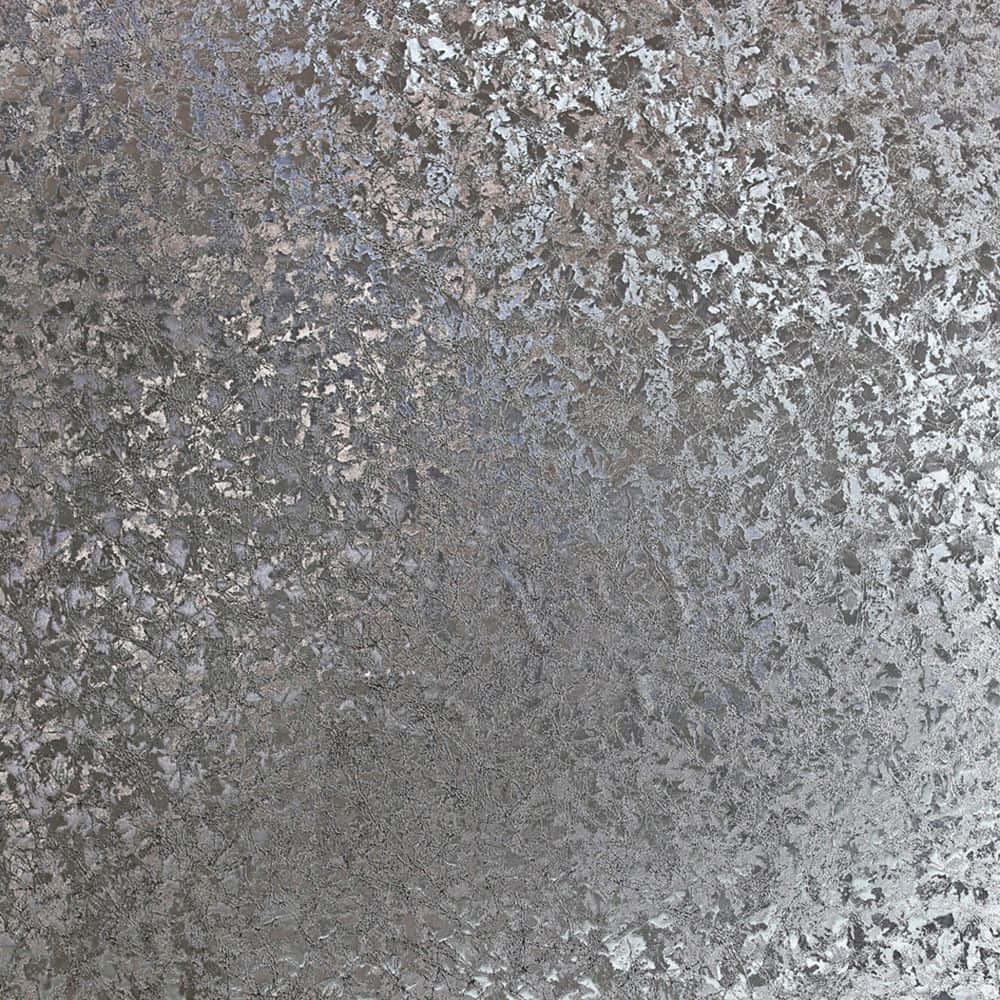 a close up of a silver textured wall