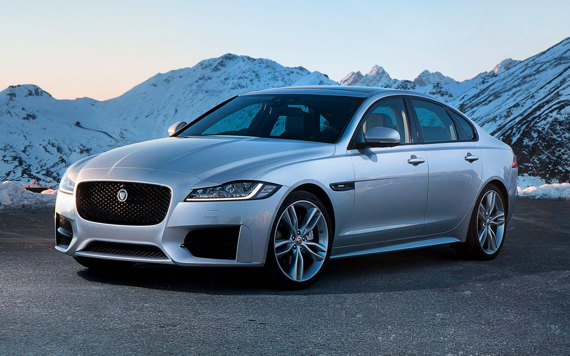 Silver Jaguar Car And Snowy Mountains Wallpaper