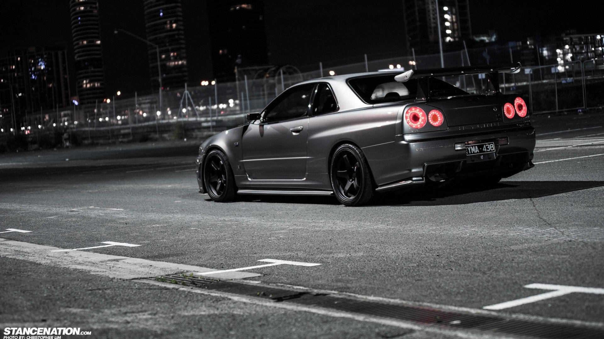Blaze Through the City Streets with this Street Racing Inspired JDM Nissan R34 Wallpaper