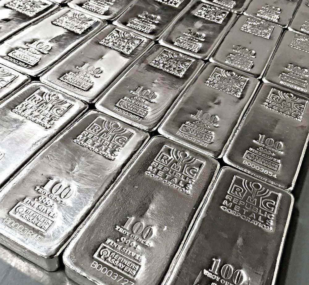 A Large Amount Of Silver Bars Are Stacked On Top Of Each Other