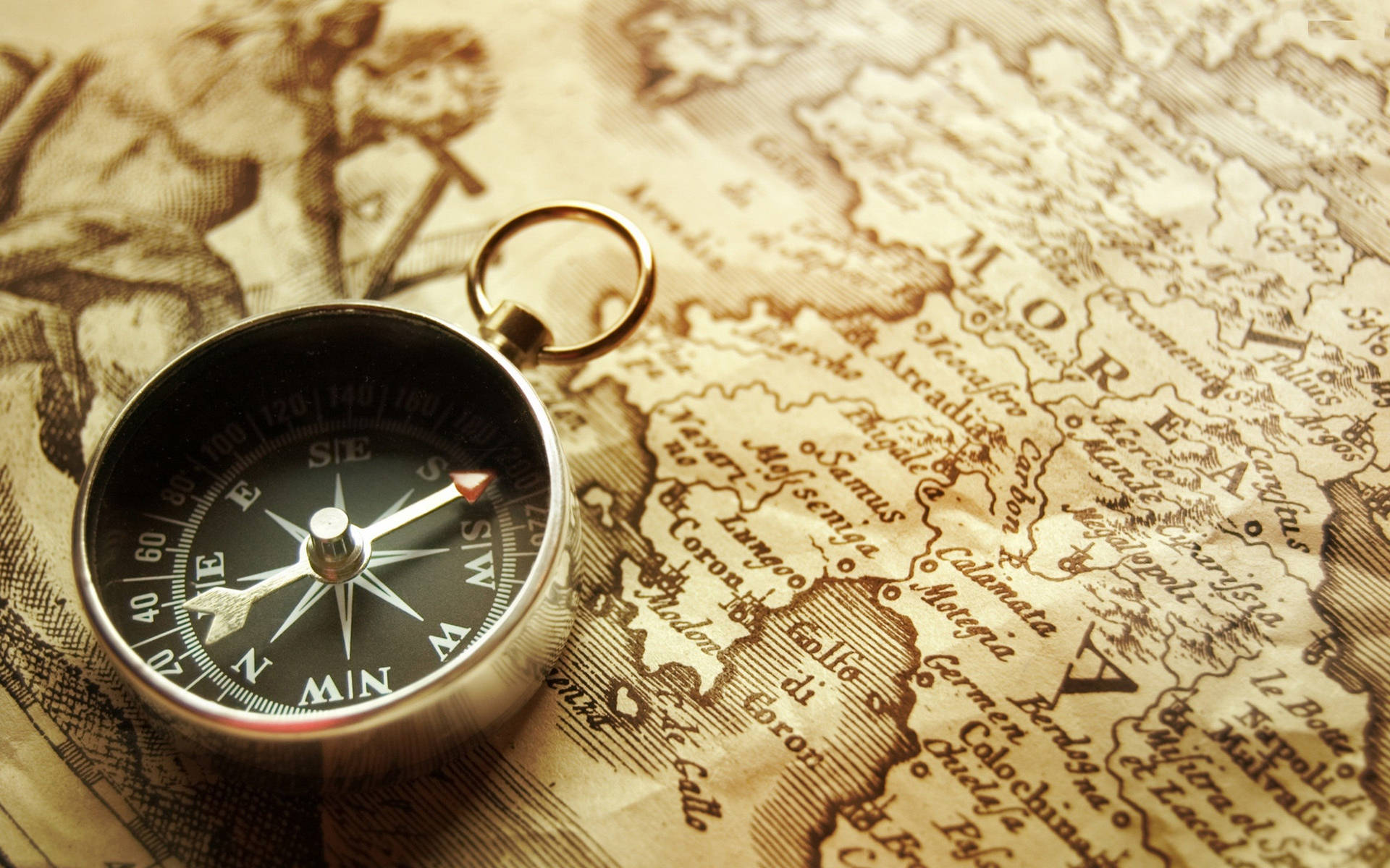 Silver Pocket Compass On A Morea Map Background