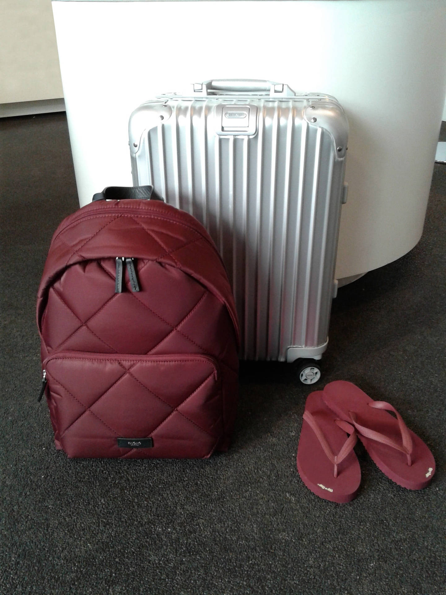Silver Rimowa Suitcase And Maroon Bag Wallpaper
