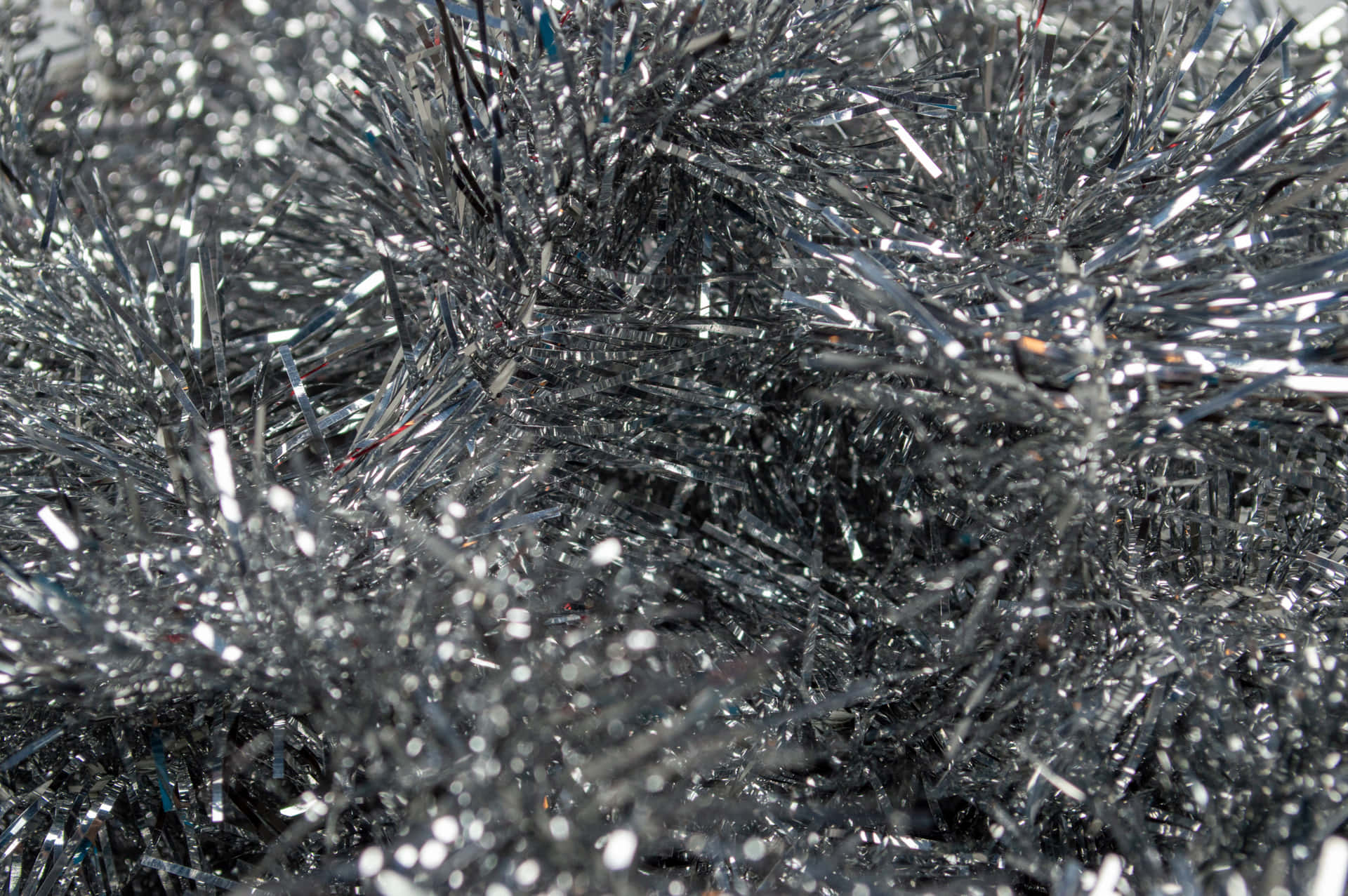 Metallic silver sparkle sparkles across a soft black backdrop