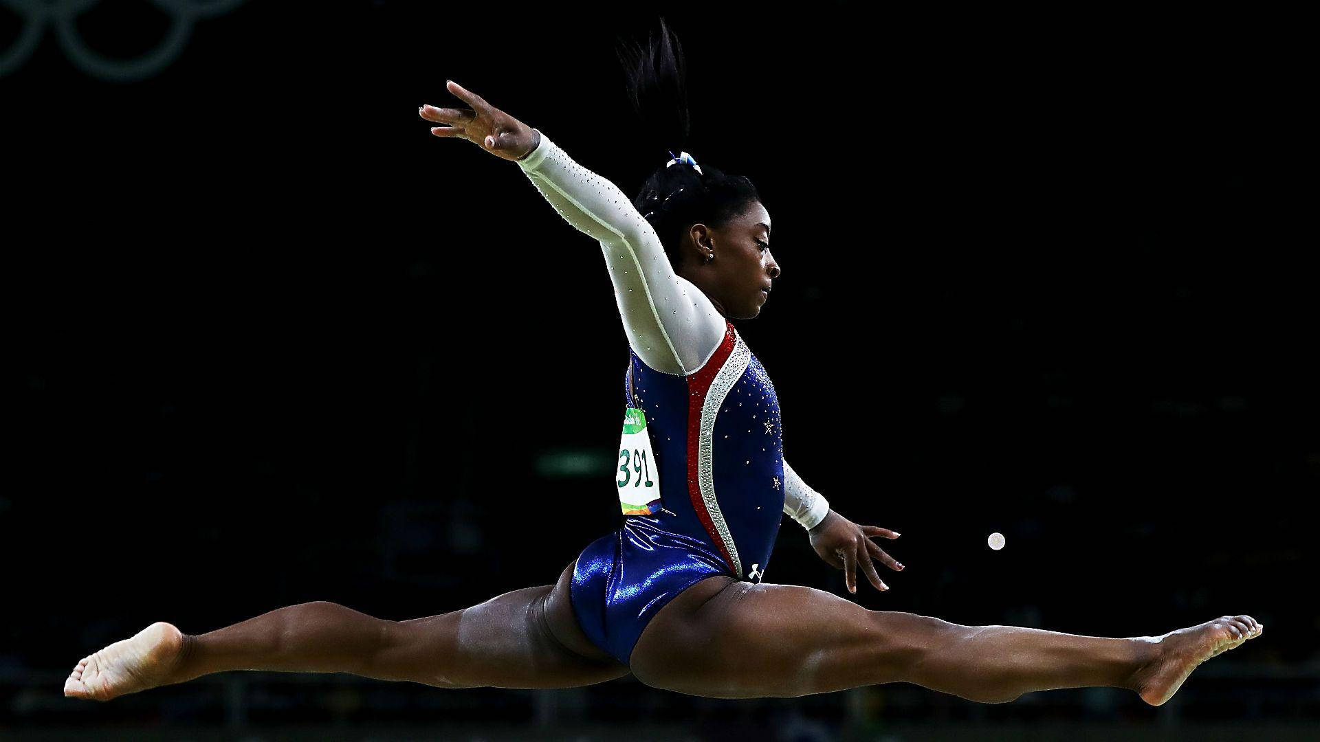 4-time Olympic Gold Medalist Simone Biles Performs On The Balance Beam Wallpaper