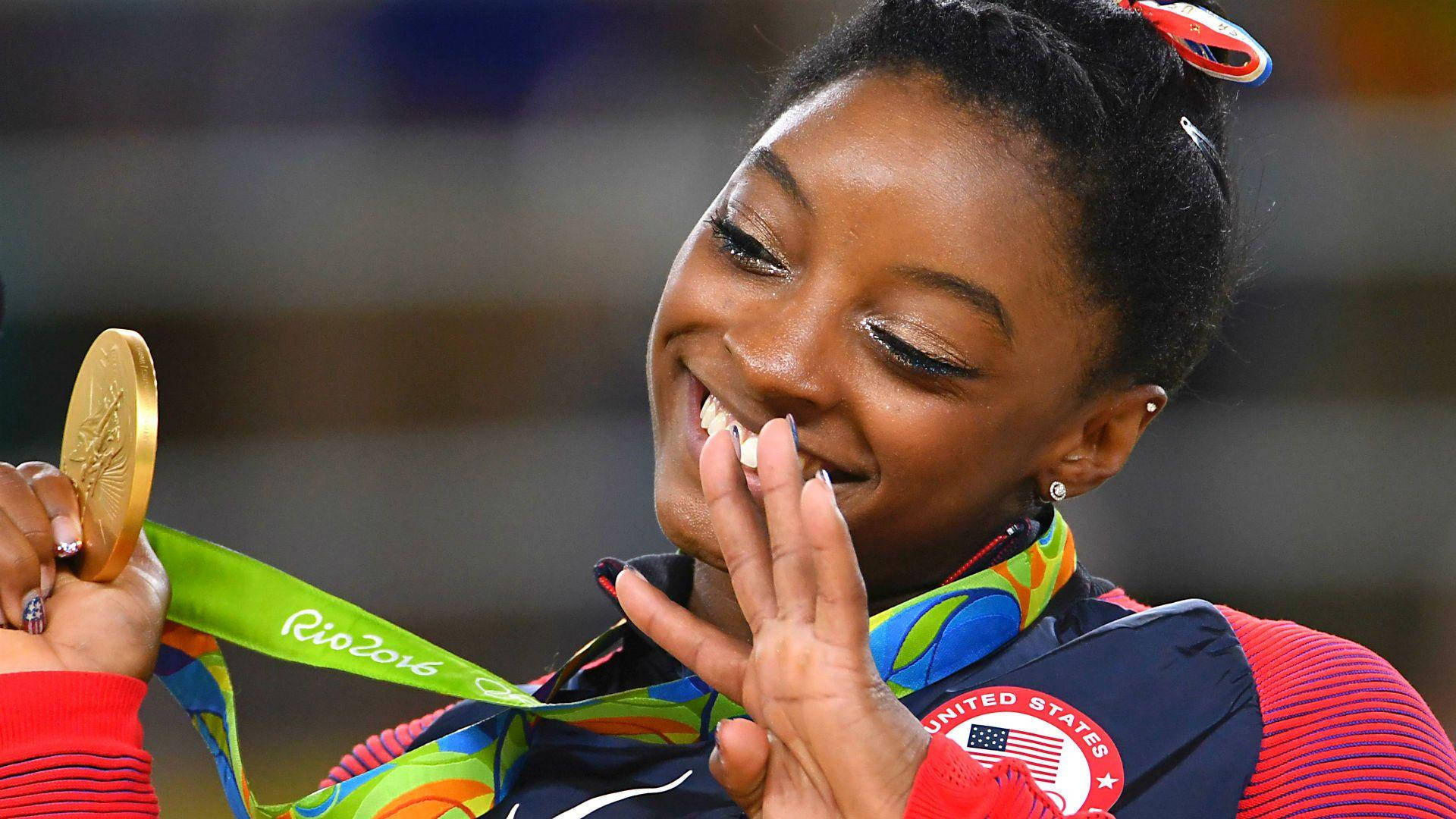 Simone Biles With Gold Medal Wallpaper