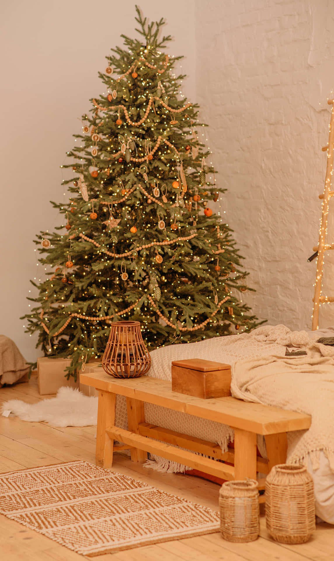 Simple Aesthetic Cute Christmas Tree Next To A Wooden Chair Wallpaper