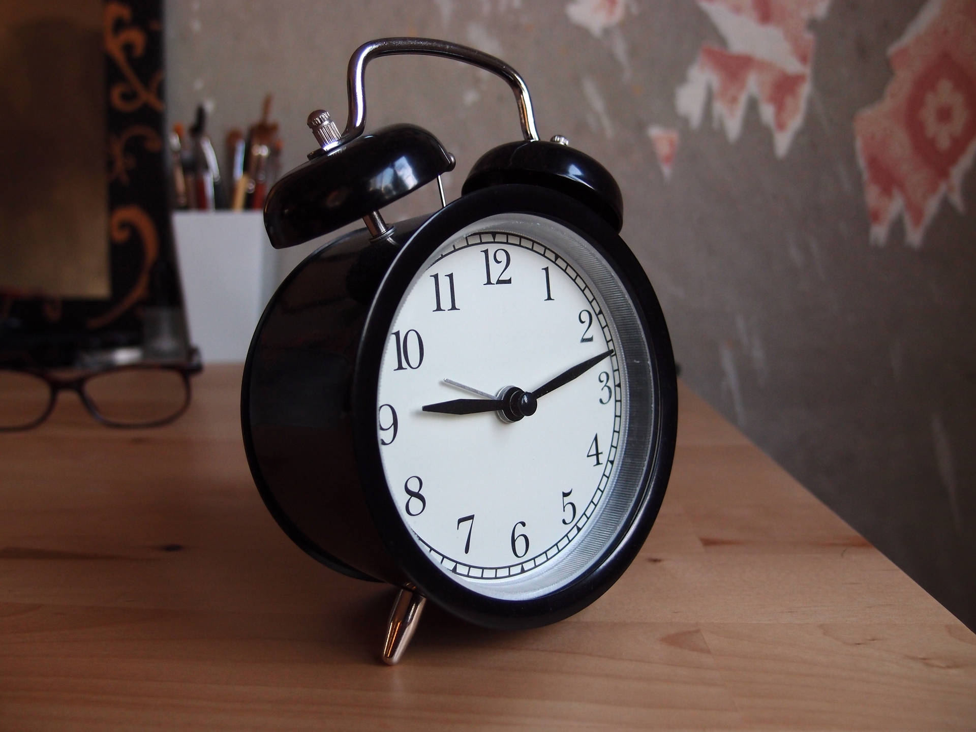 Black Alarm Clock on a tabletop Wallpaper