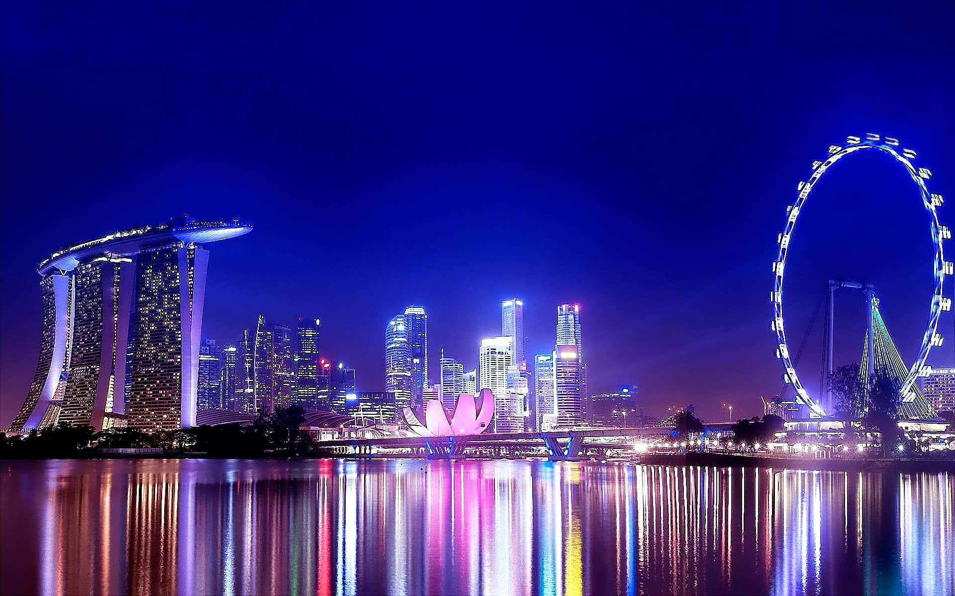 Singapore City At Night With The Marina Bay Ferris Wheel