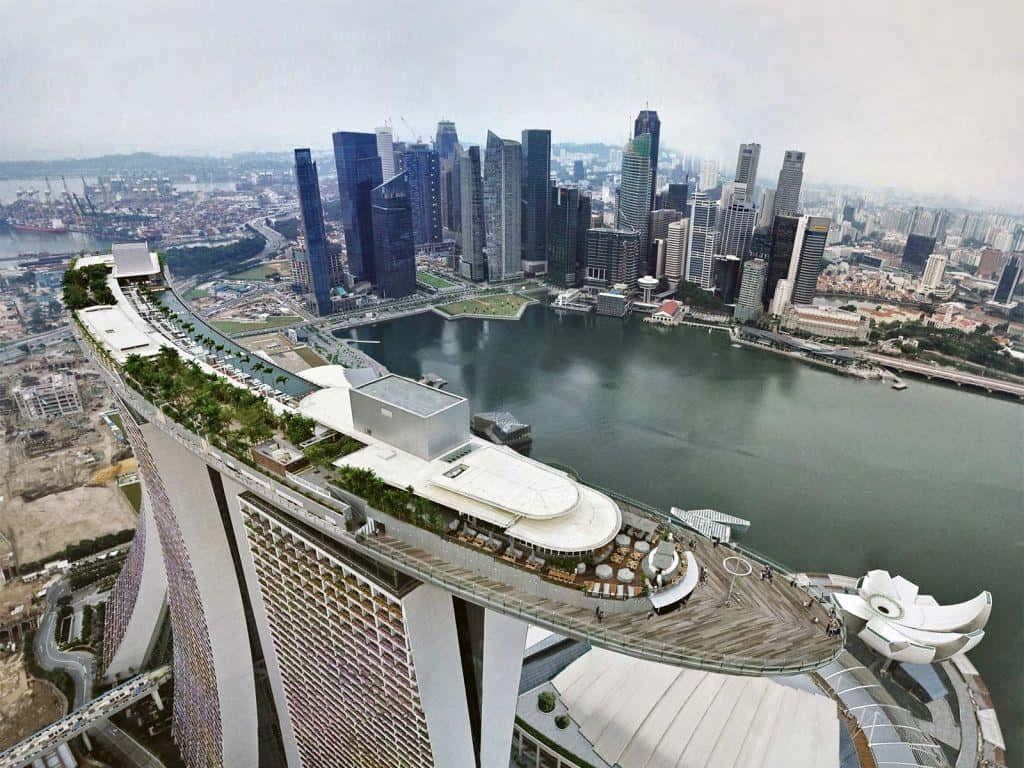 The Marina Bay Sands Hotel Is A Large Building With A Large Roof