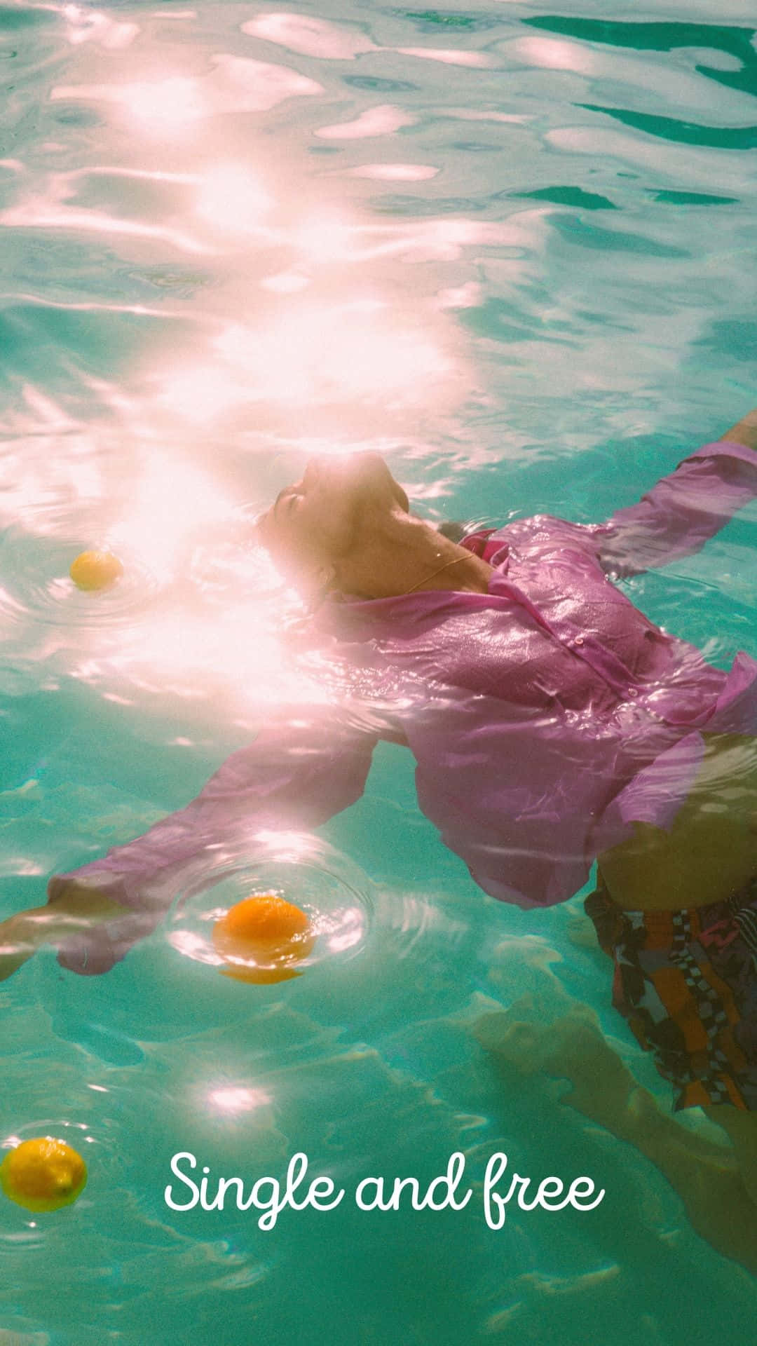A Woman In A Pink Shirt Floating In The Water