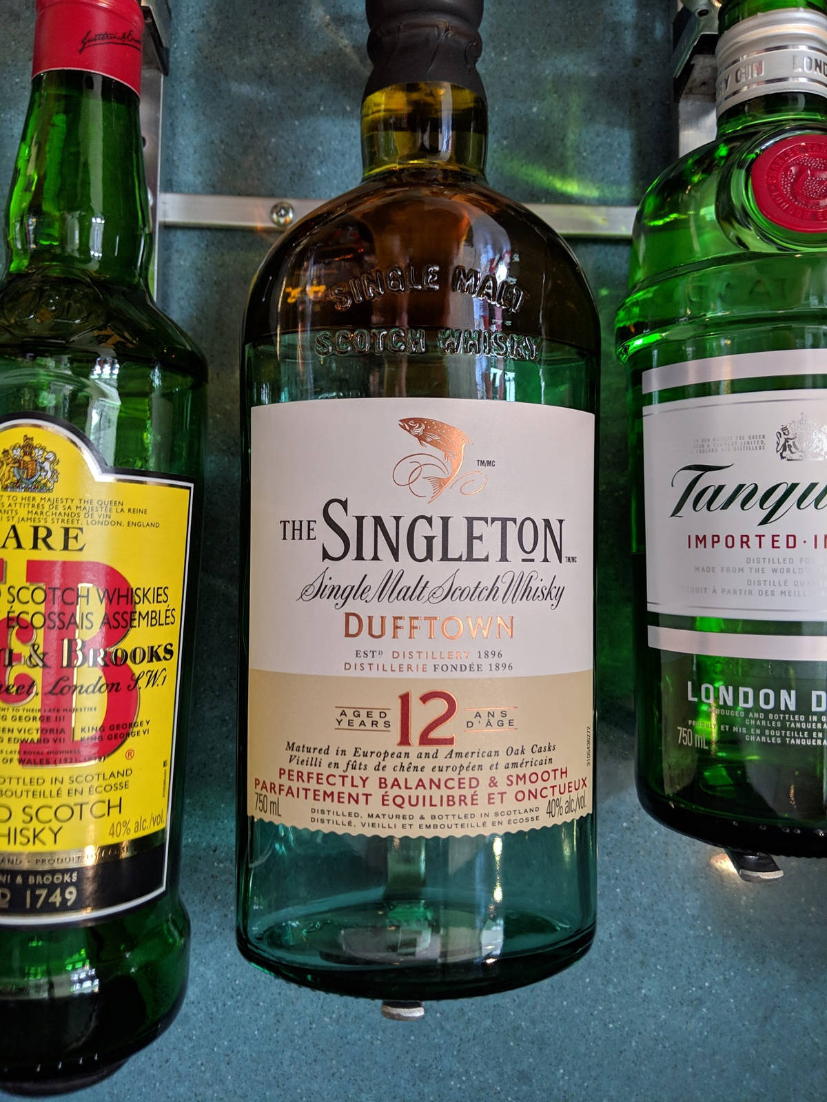 Caption: "A Bottle of Singleton Whisky on a Bar Counter" Wallpaper