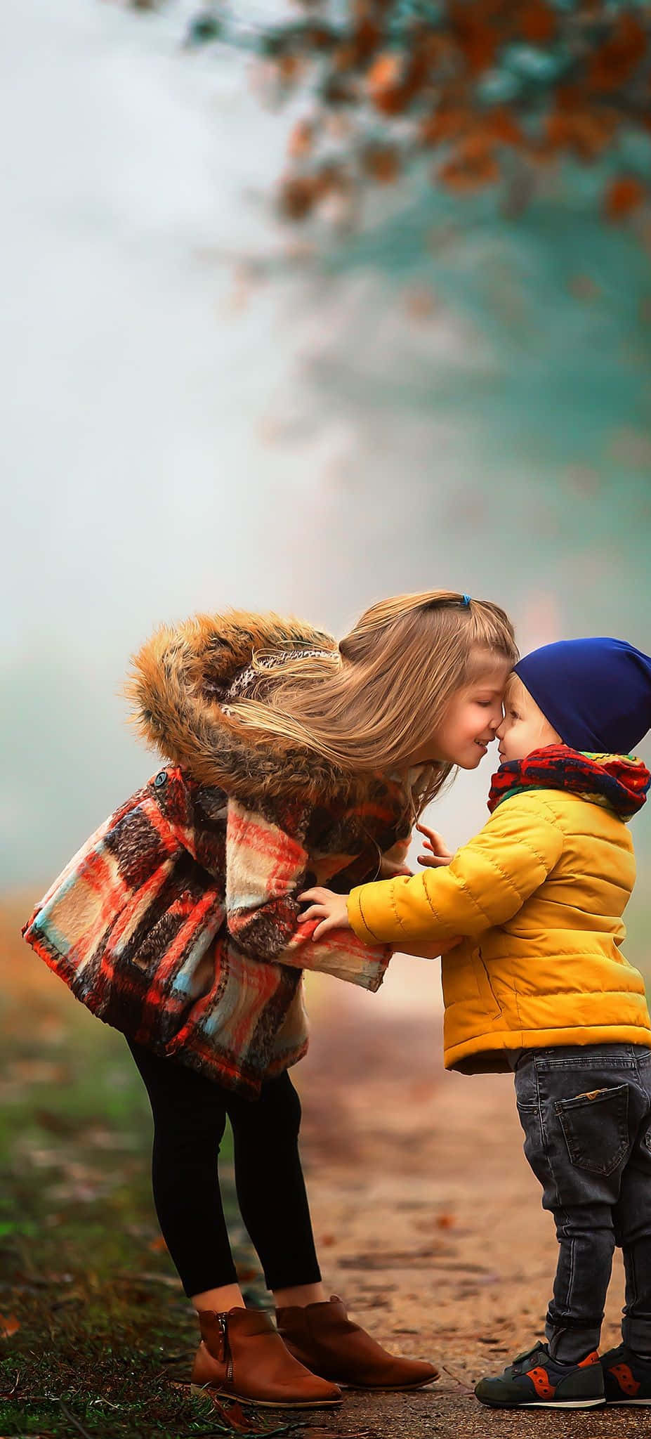 Download A Boy And Girl Kissing In The Autumn | Wallpapers.com