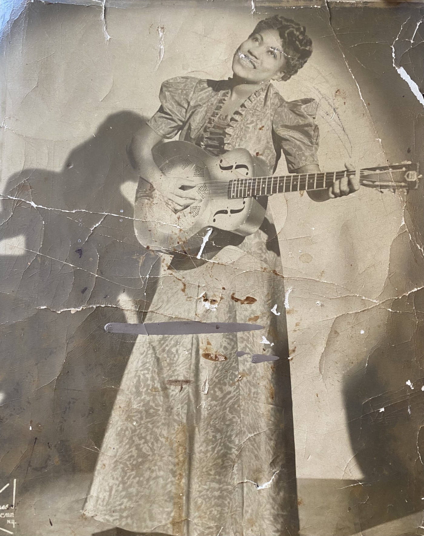 Caption: Sister Rosetta Tharpe Strumming Her Guitar on Vintage Photo Wallpaper