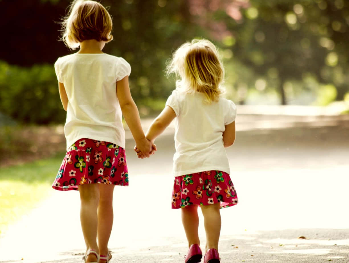 Sisters Walking Handin Hand Wallpaper