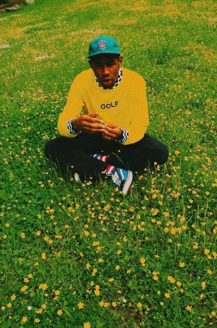 Tyler The Creator sits in contemplation Wallpaper