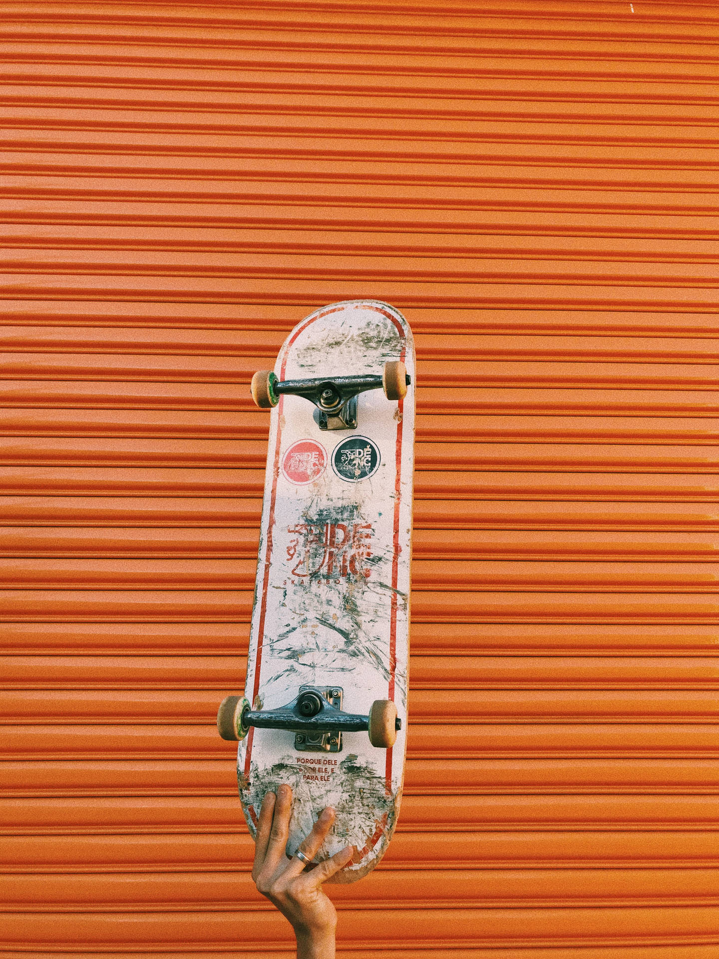 Skateboard In Orange Gate Background Wallpaper