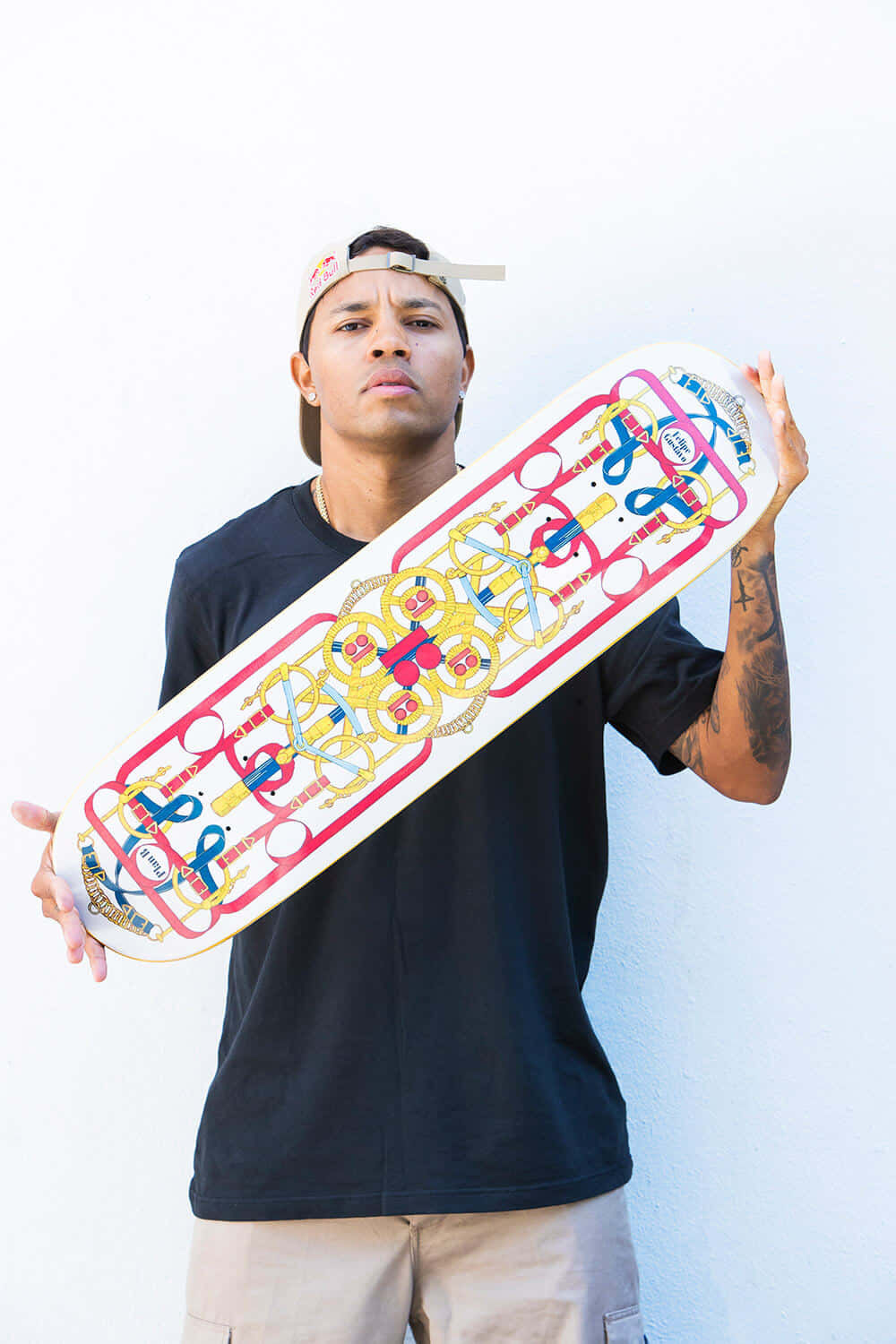 A Man Holding A Skateboard