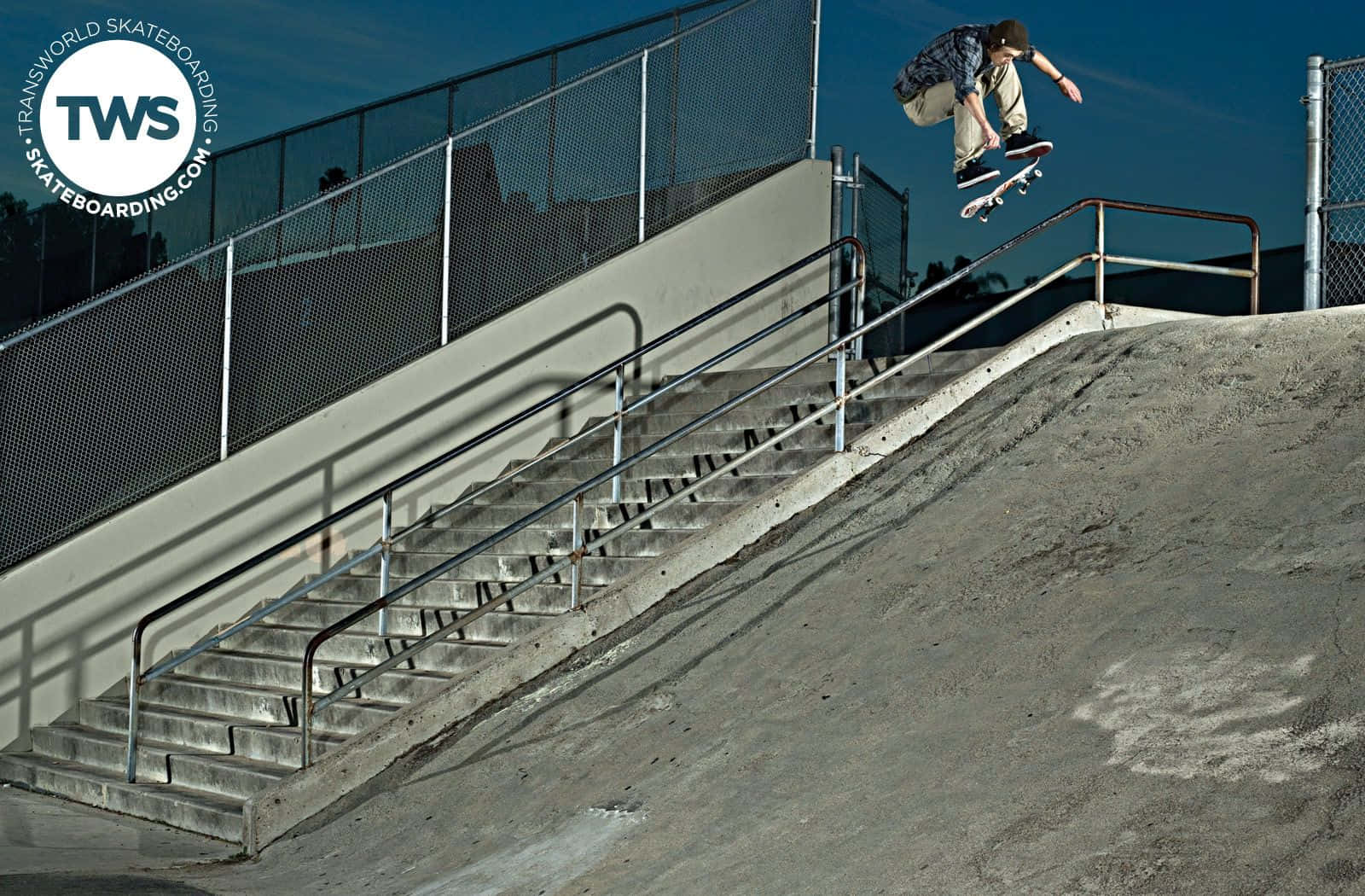 Skateboarder Midair Trick Over Stairs.jpg Wallpaper
