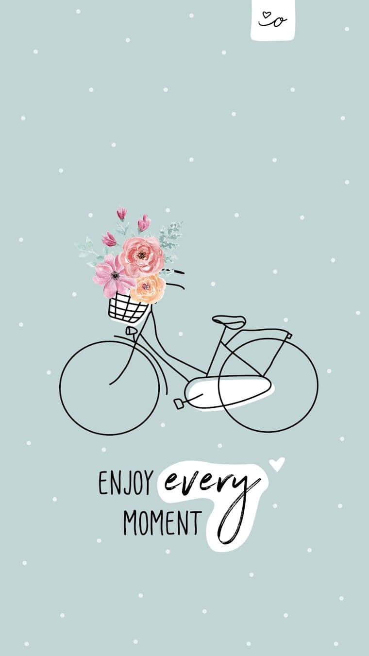 A Bicycle With Flowers In A Basket And The Words Enjoy Every Moment Wallpaper