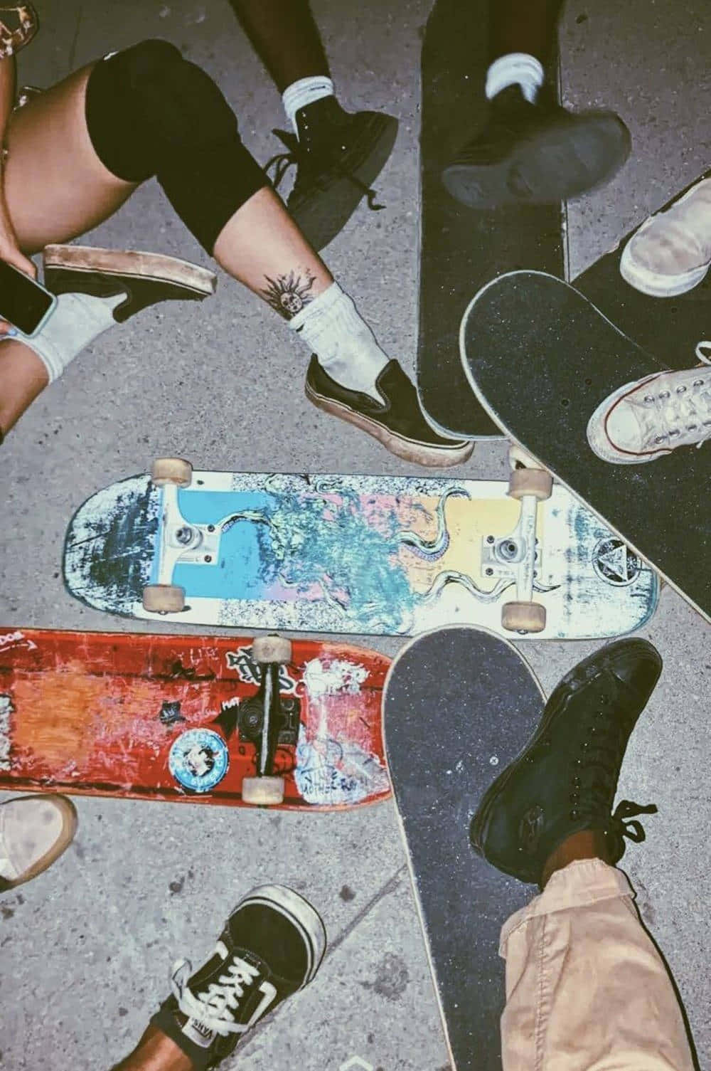 A Group Of People Sitting On Skateboards Wallpaper