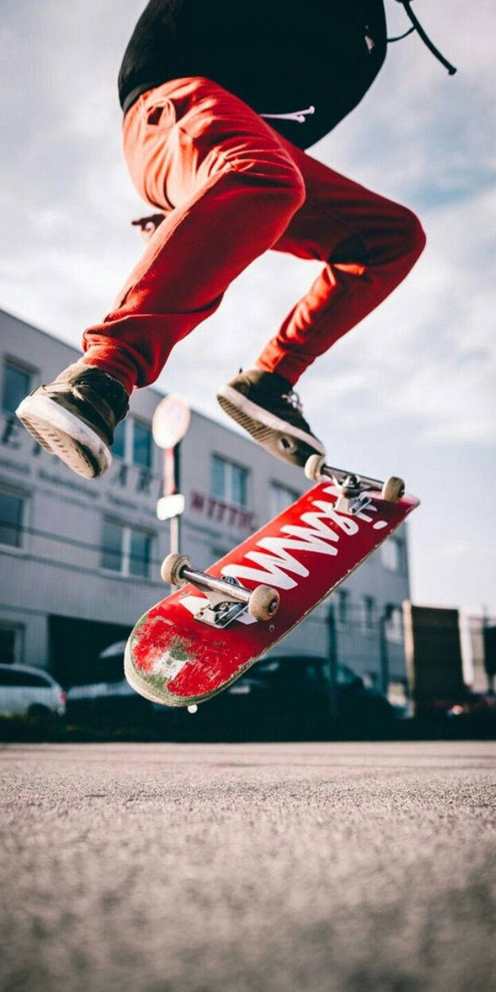 Skater With Red Skateboard Iphone Wallpaper
