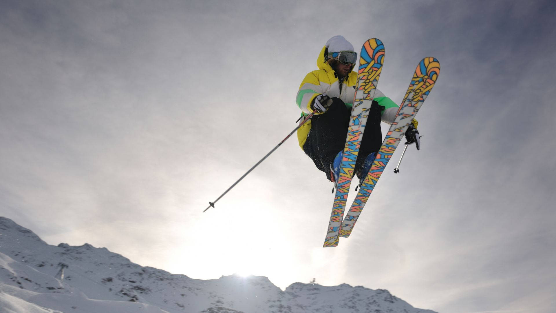 Caption: Intense Action Mid-Air - Ski Jumper In Motion Wallpaper