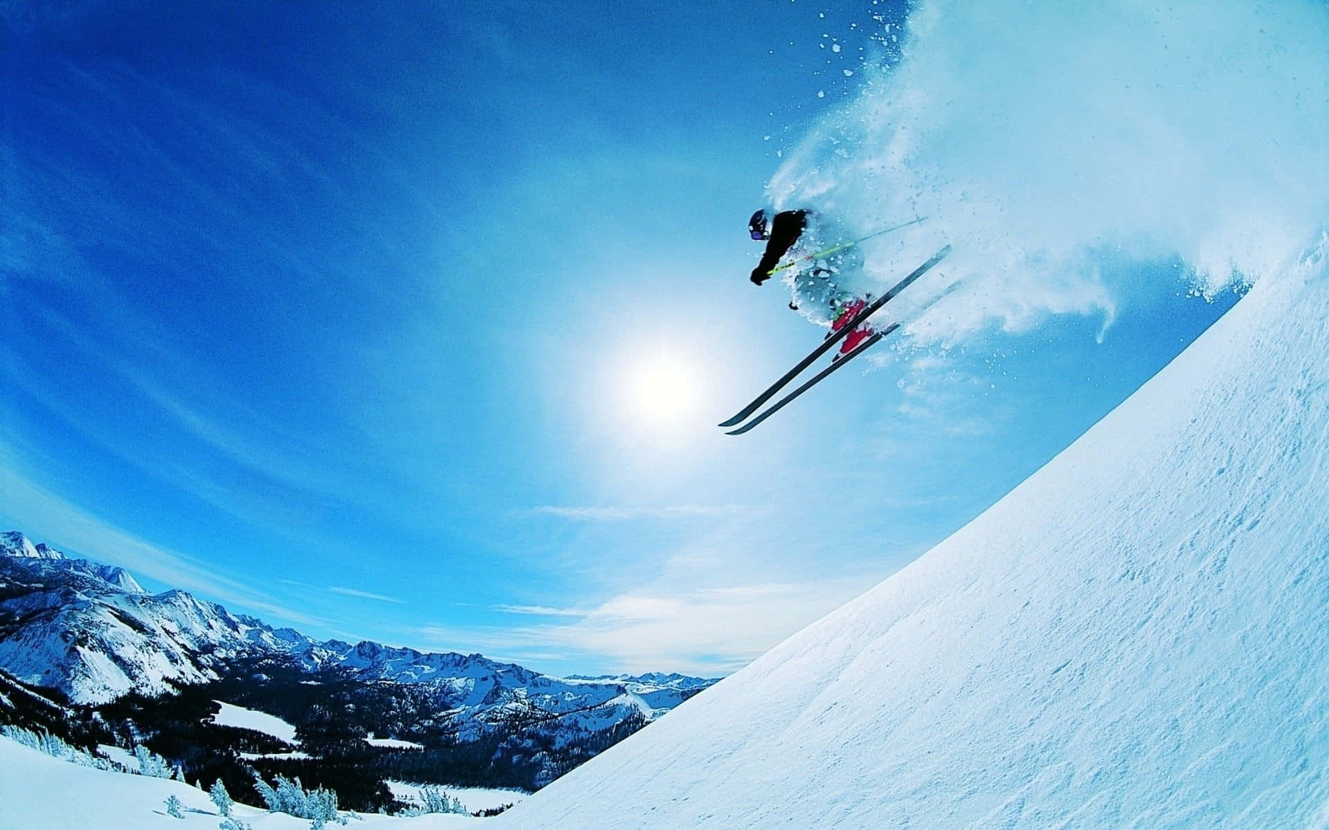 Experience Thrilling Ski Slopes With Amazing Mountain Views Wallpaper