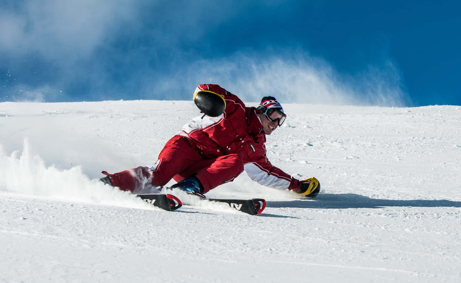 A Man Is Skiing Down A Snowy Slope
