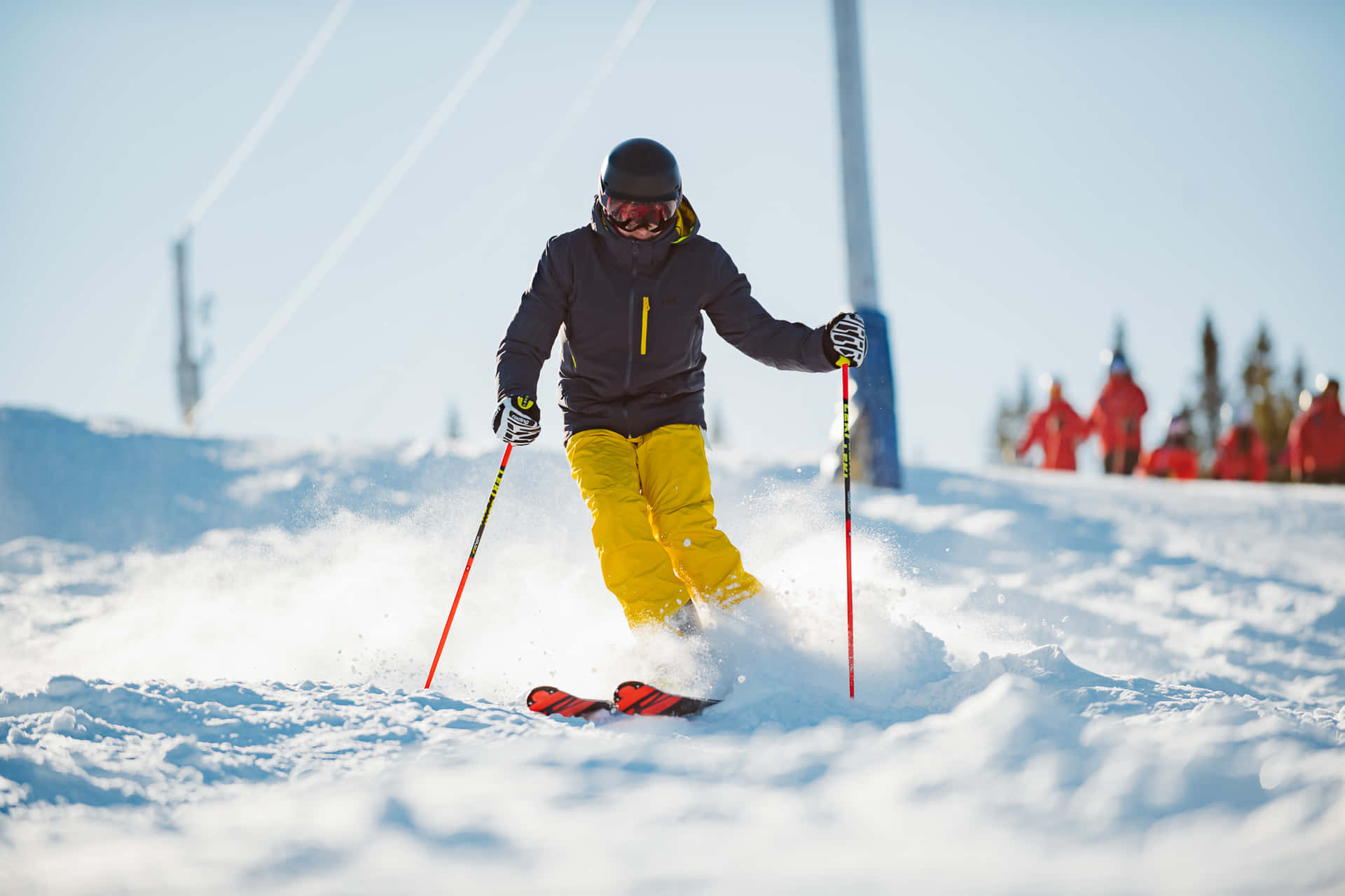 A Man Skiing Down A Snowy Slope