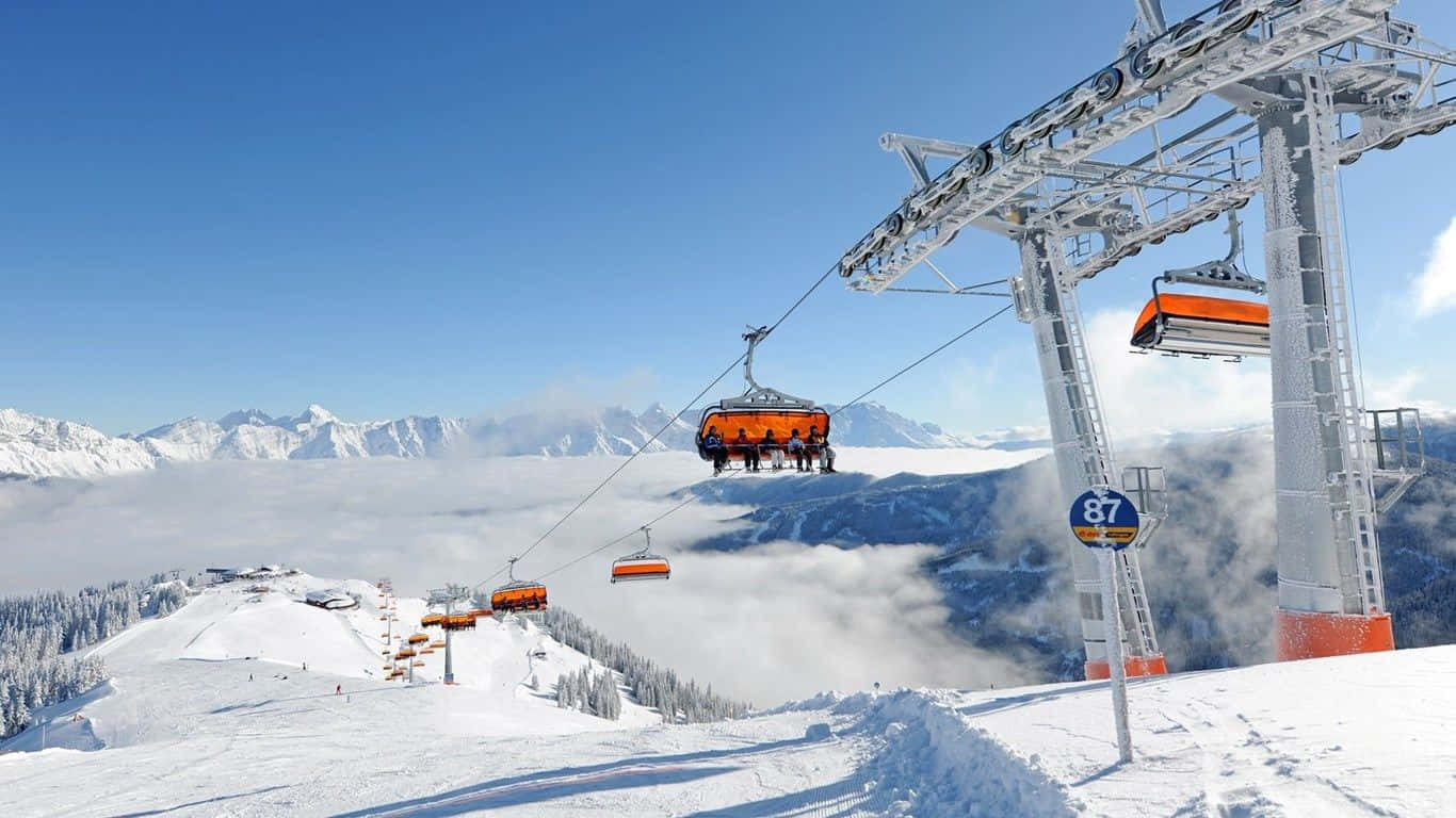 Majestic Ski Resort with Snow-Covered Mountains Wallpaper