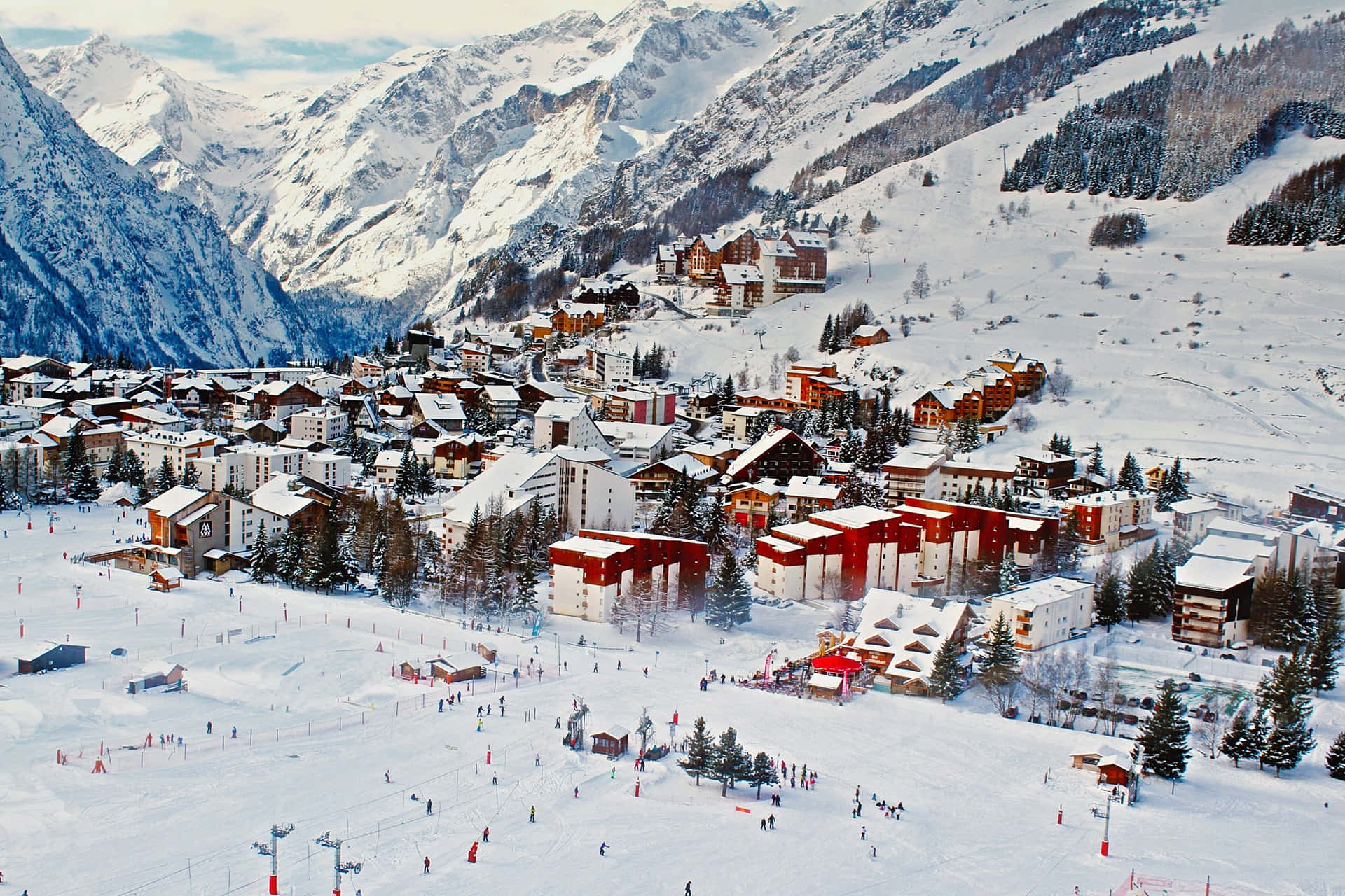 Captivating Ski Resort amidst Snowy Mountains Wallpaper