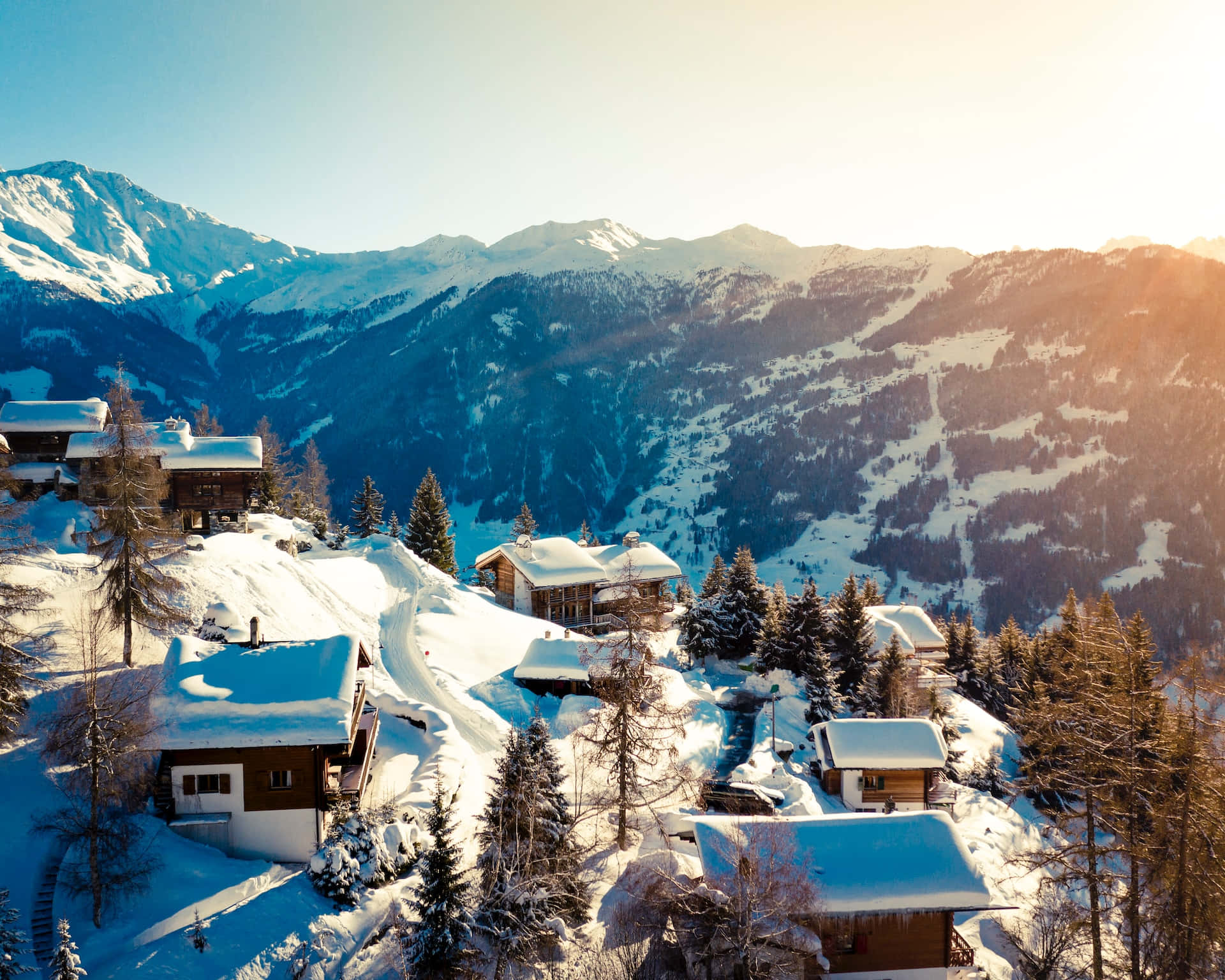 Majestic Ski Resort Amidst Snowy Mountains Wallpaper