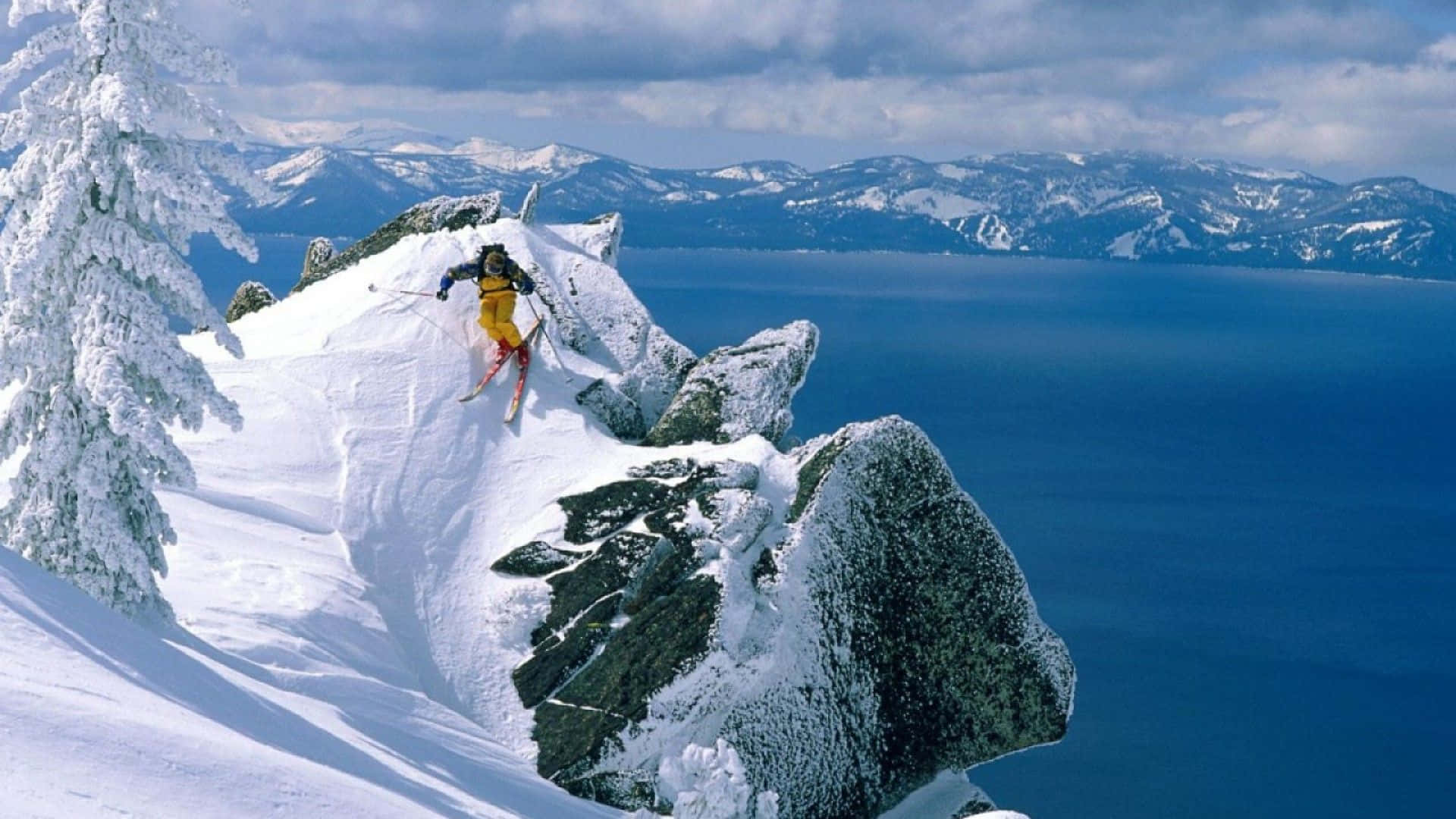 Skier taking a downhill adventure in the snowy mountains.