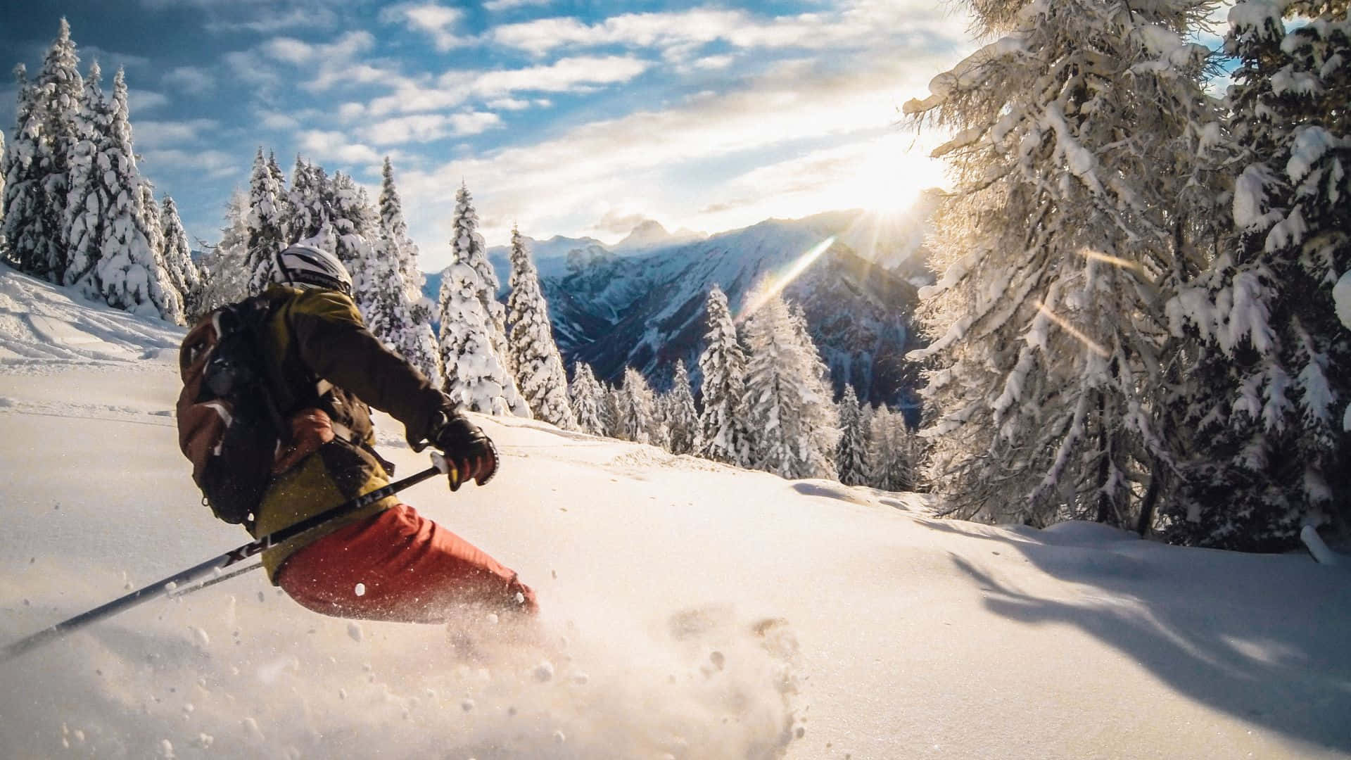 Enjoy the thrill of Skiing on a snow-capped mountain Wallpaper