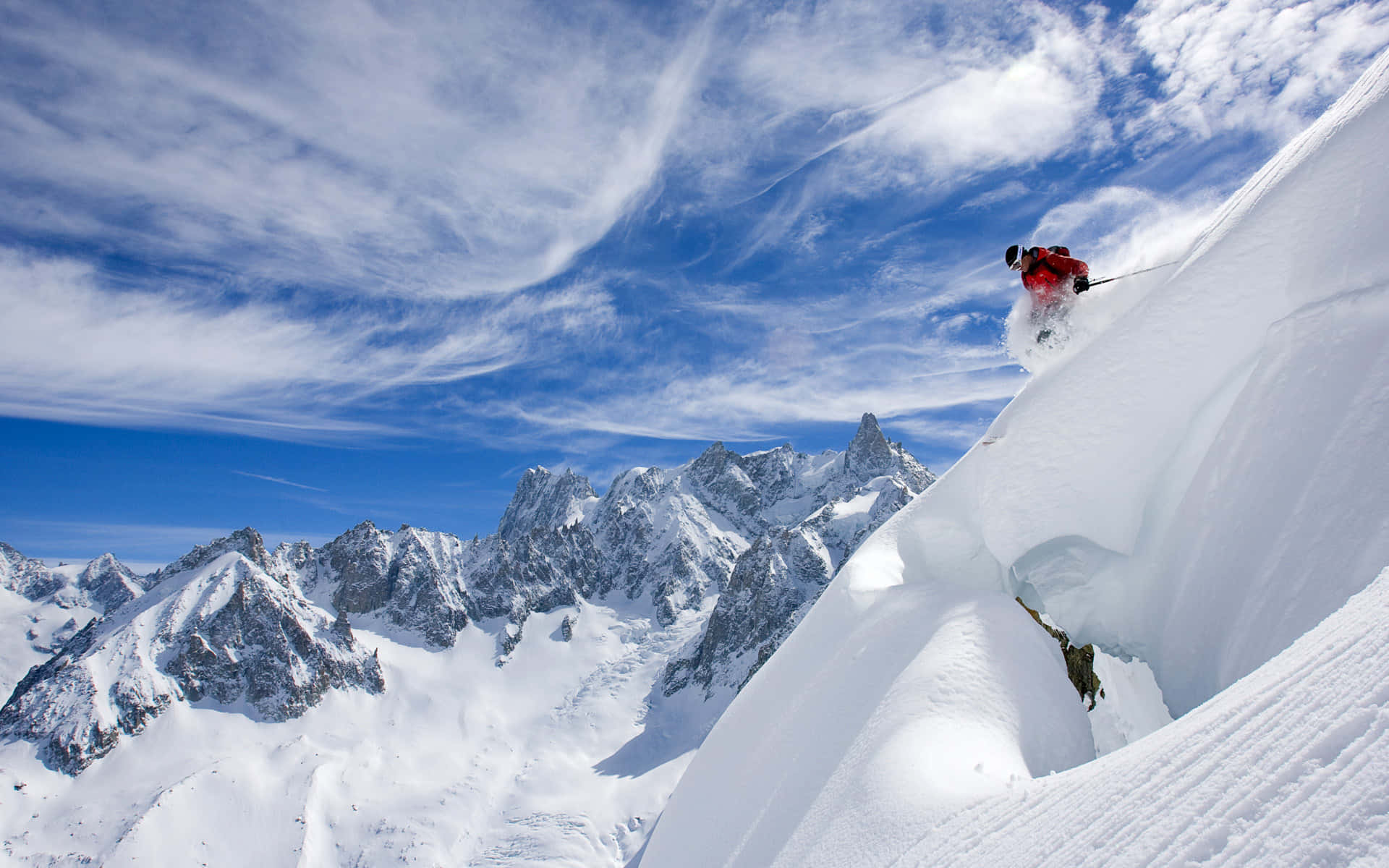 Adventurous Skier Descending a Snowy Mountain Slope