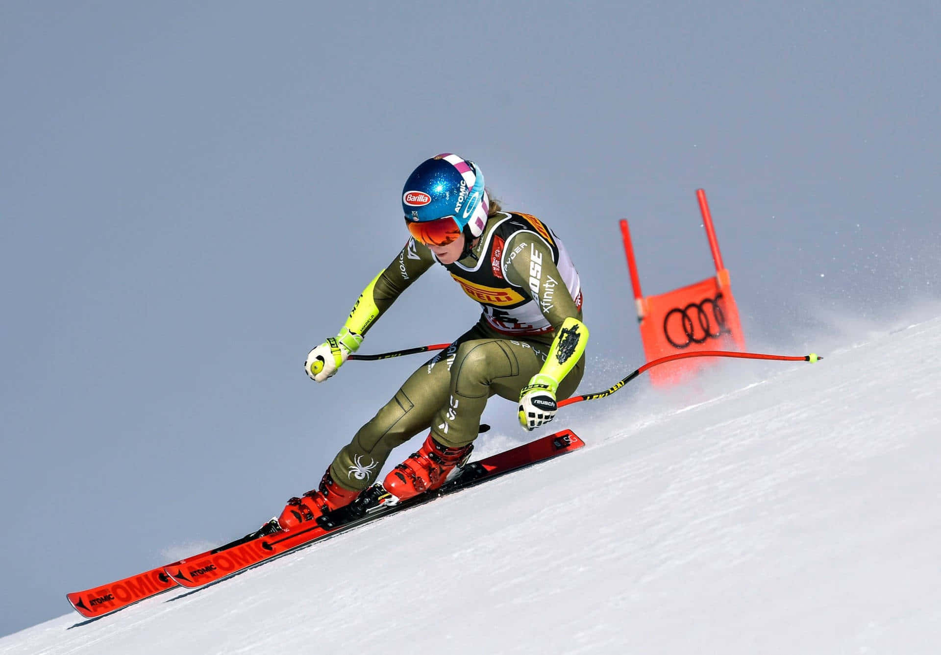 A skier carving through fresh powder on a sunny slope