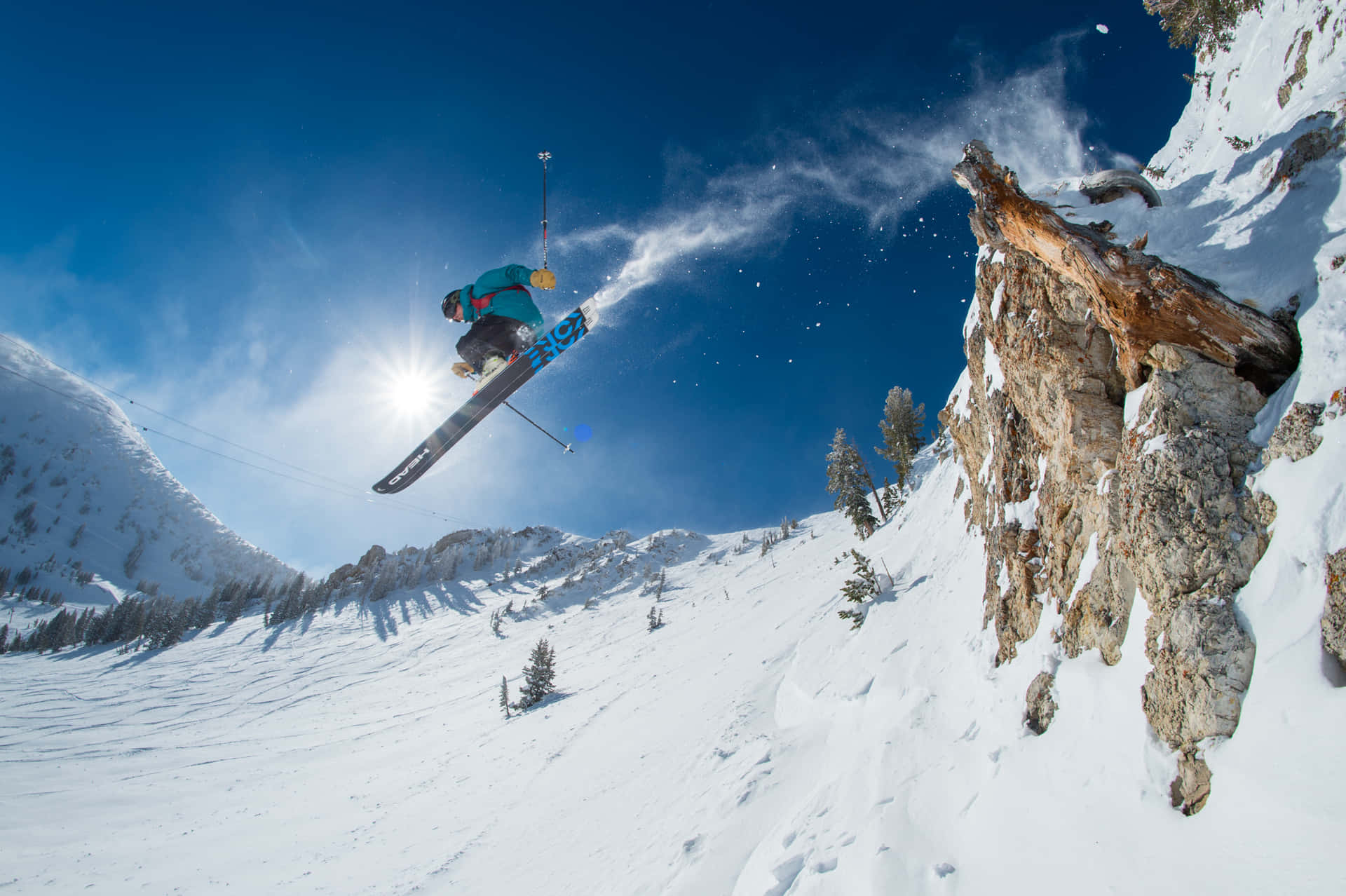 A Skier Is Jumping Off A Cliff Wallpaper