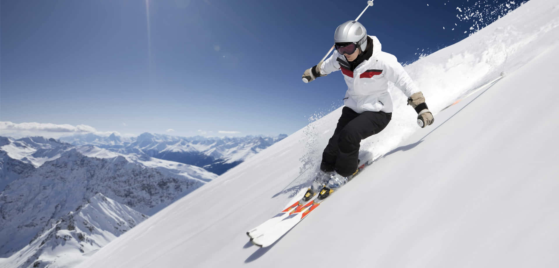 Enjoy the thrill of skiing in the snow-capped mountains Wallpaper