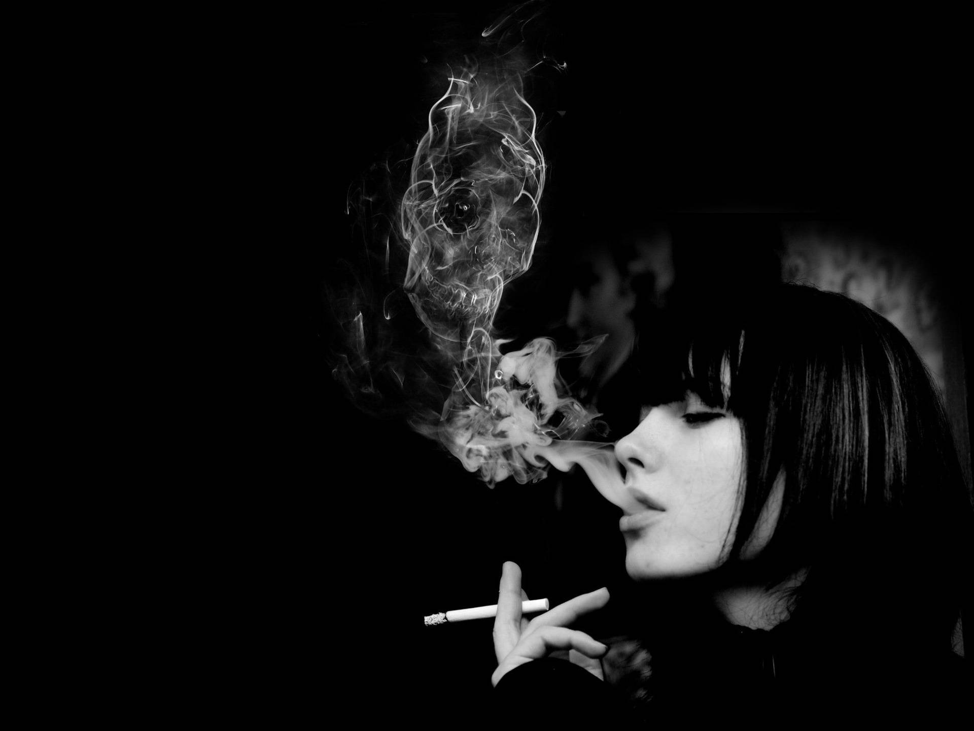 An illuminated skull surrounded by eerie smokes of a mysterious woman. Wallpaper